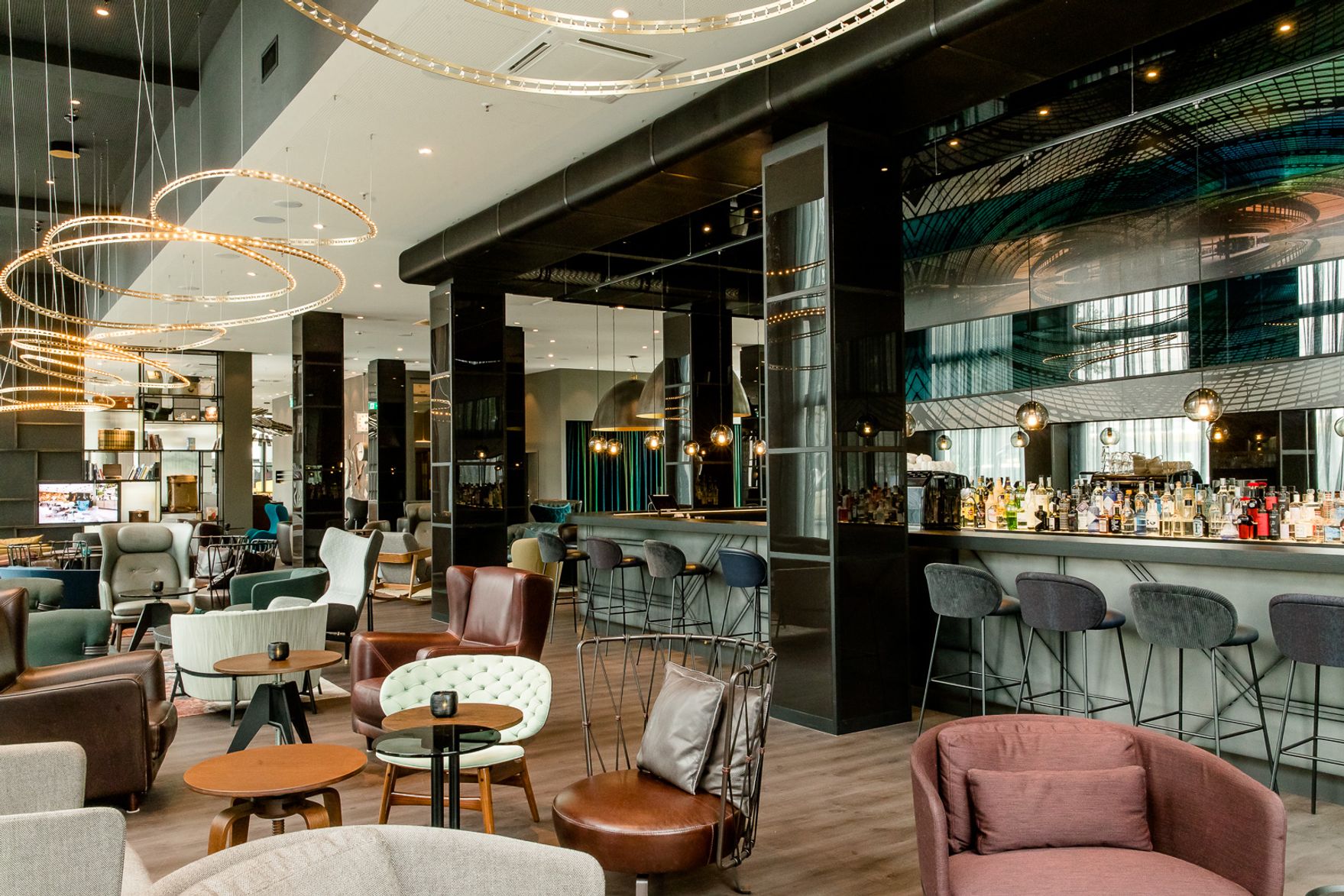 Hotel Berlin Hauptbahnhof Motel One große und lichtdurchflutete Lounge mit mehreren Sitzgelegenheiten sowie Bar mit Barhockern