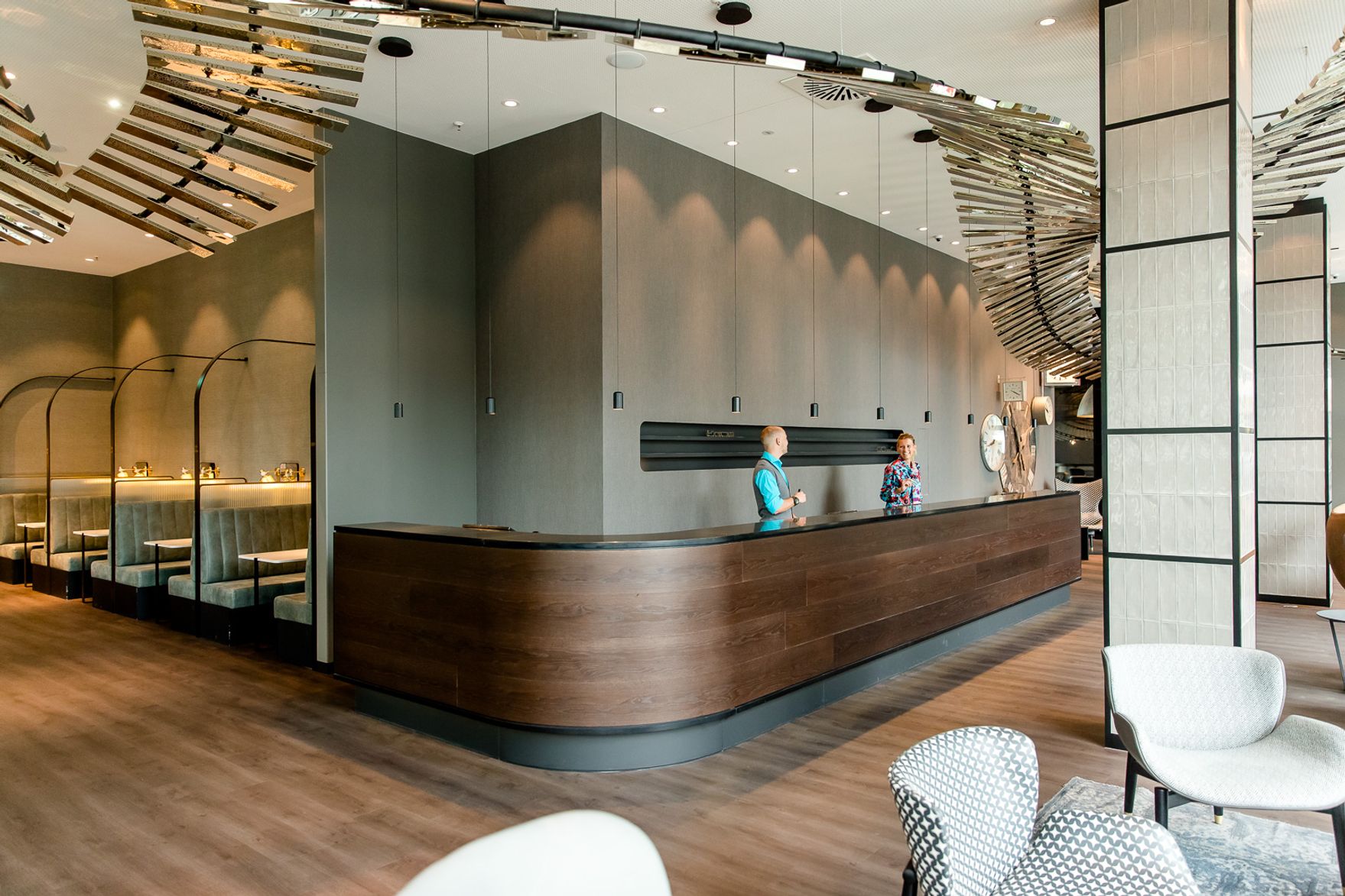 Designhotel Berlin Hauptbahnhof Motel One helle Rezeption mit zwei Mitarbeitenden bei der Arbeit