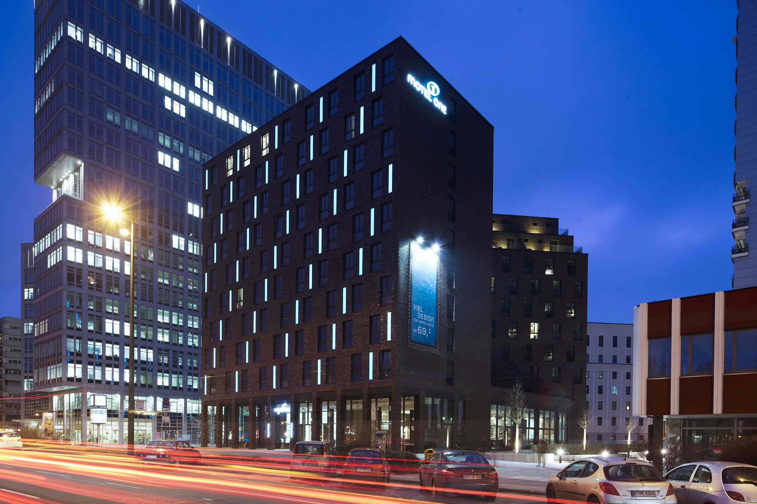 hotel Berlin Spittelmarkt Motel One building at dusk with illuminated logo