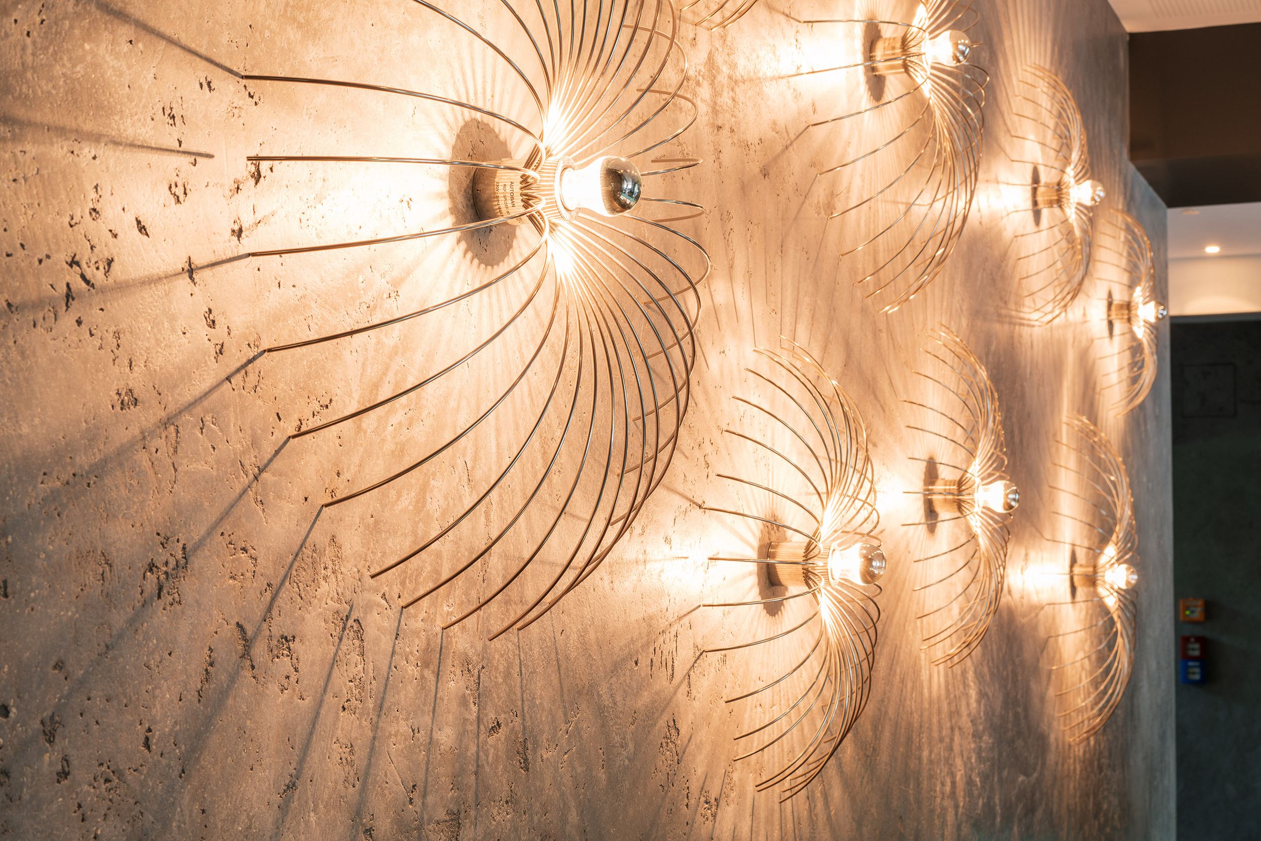 hotel Berlin Tiergarten Motel One view of a bright wall with several glowing designer lamps