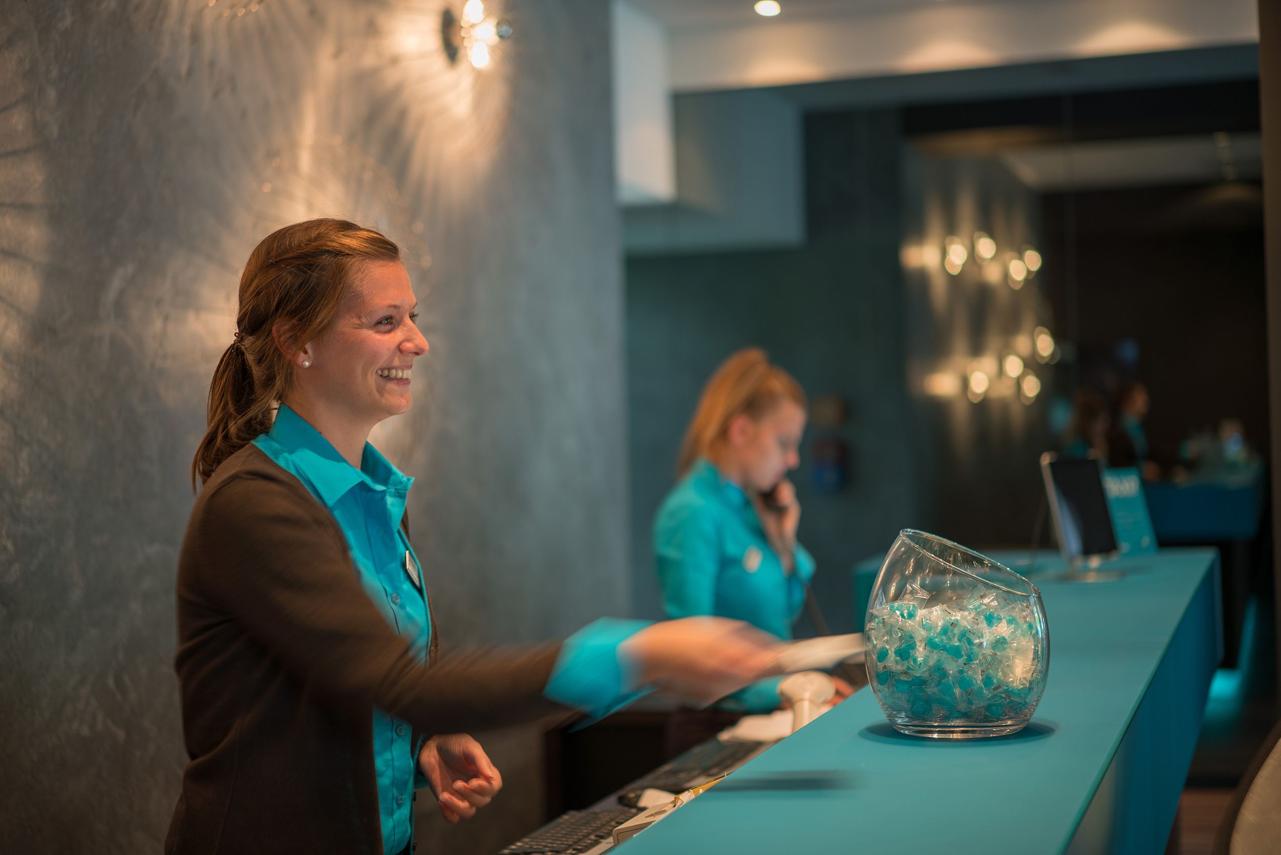 Hotel Berlin Tiergarten Motel One Rezeption mit zwei Mitarbeiterinnen bei der Arbeit