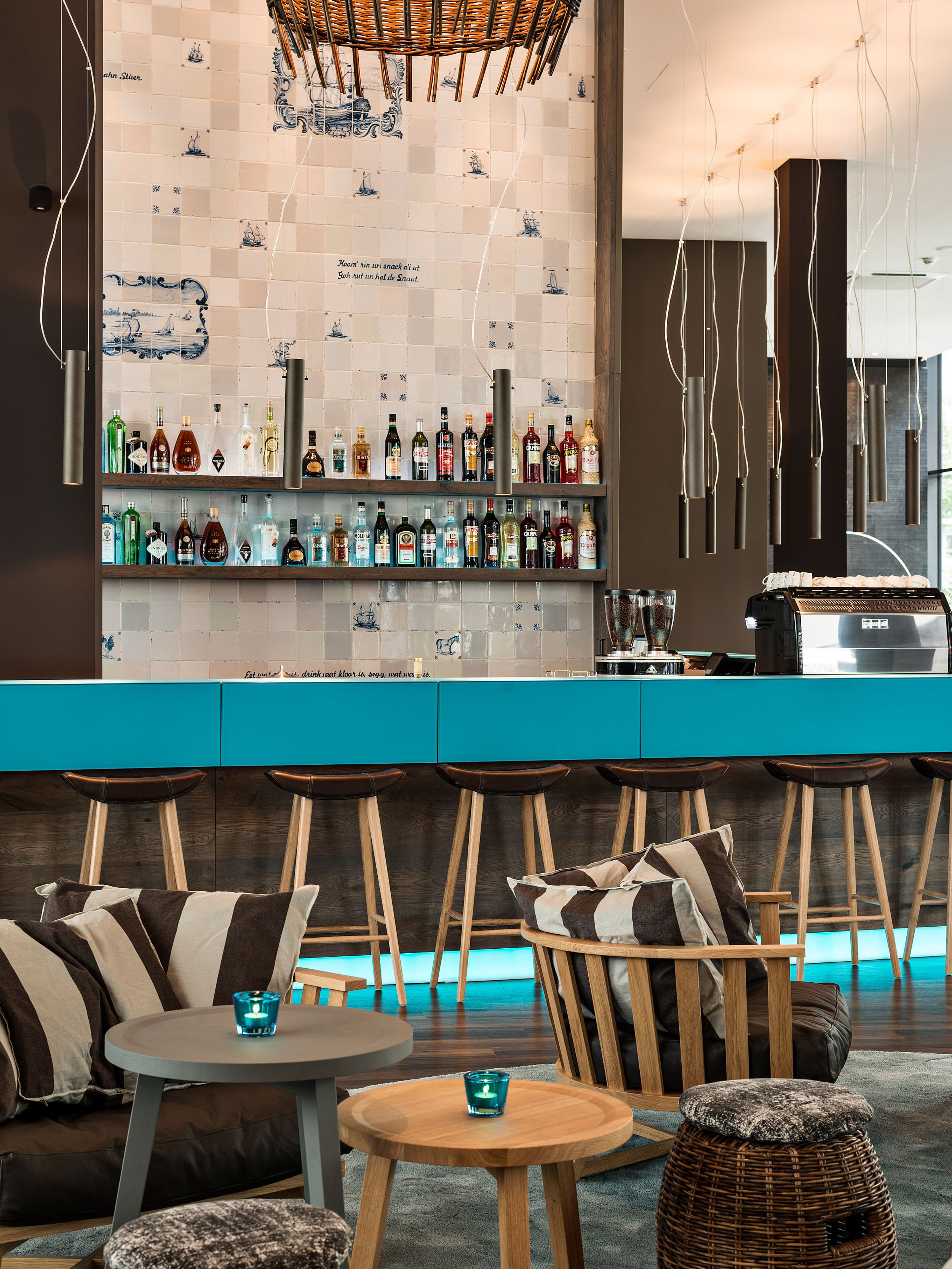 hotel Bremen Motel One bright bar area with armchairs in the foreground and bar stools at the bar counter