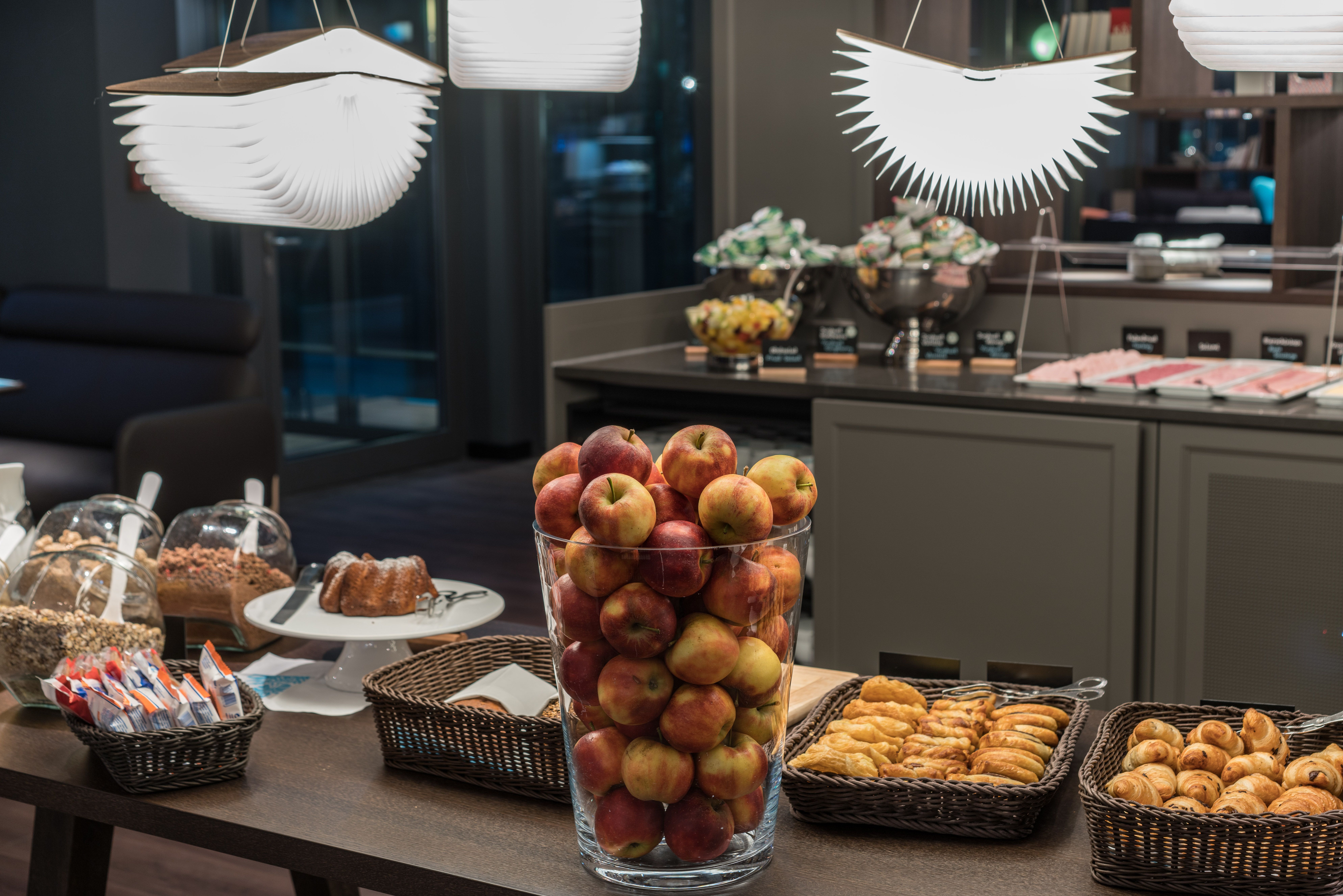 hotel Dresden Palaisplatz Motel One breakfast buffet with baked goods and a large bowl of apples