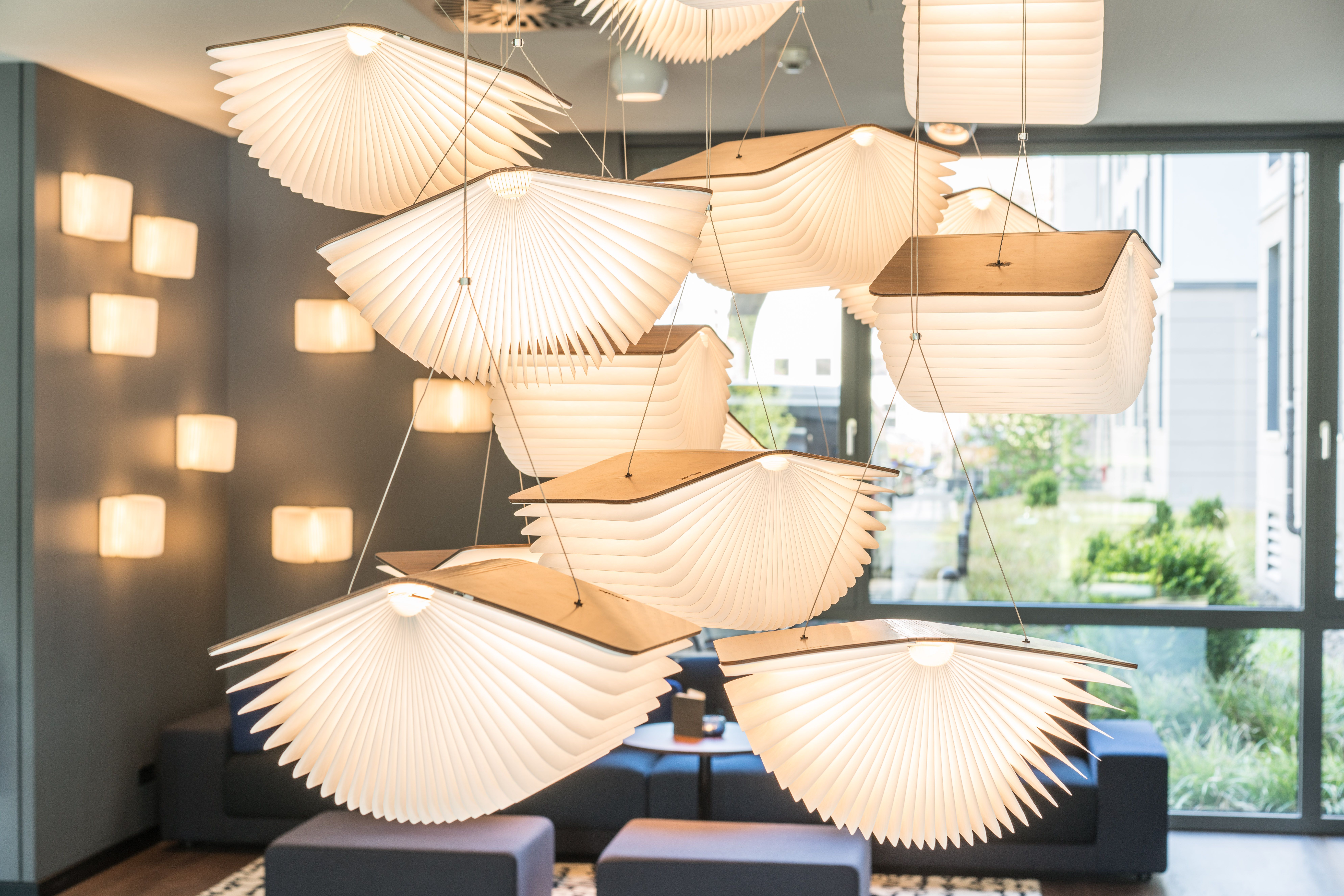 designhotel Dresden Palaisplatz Motel One close-up of several ceiling lamps in the shape of open books