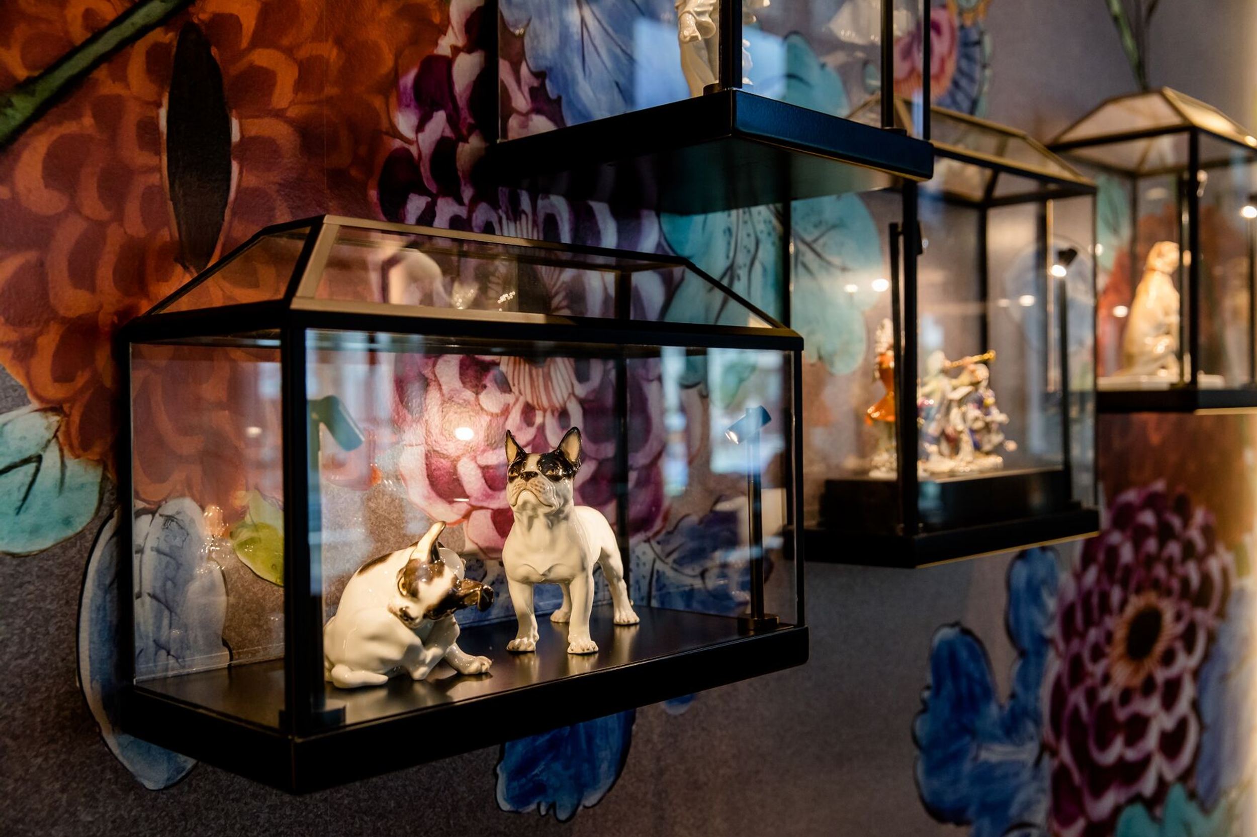 hotel Dresden am Zwinger Motel One display cabinets on the wall with white dog figurines