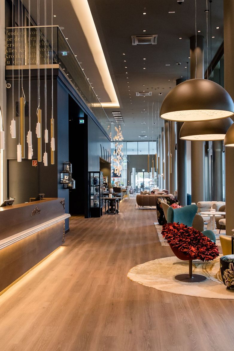 hotel Dresden am Zwinger Motel One long corridor with a view of the reception on the left and the lounge on the right