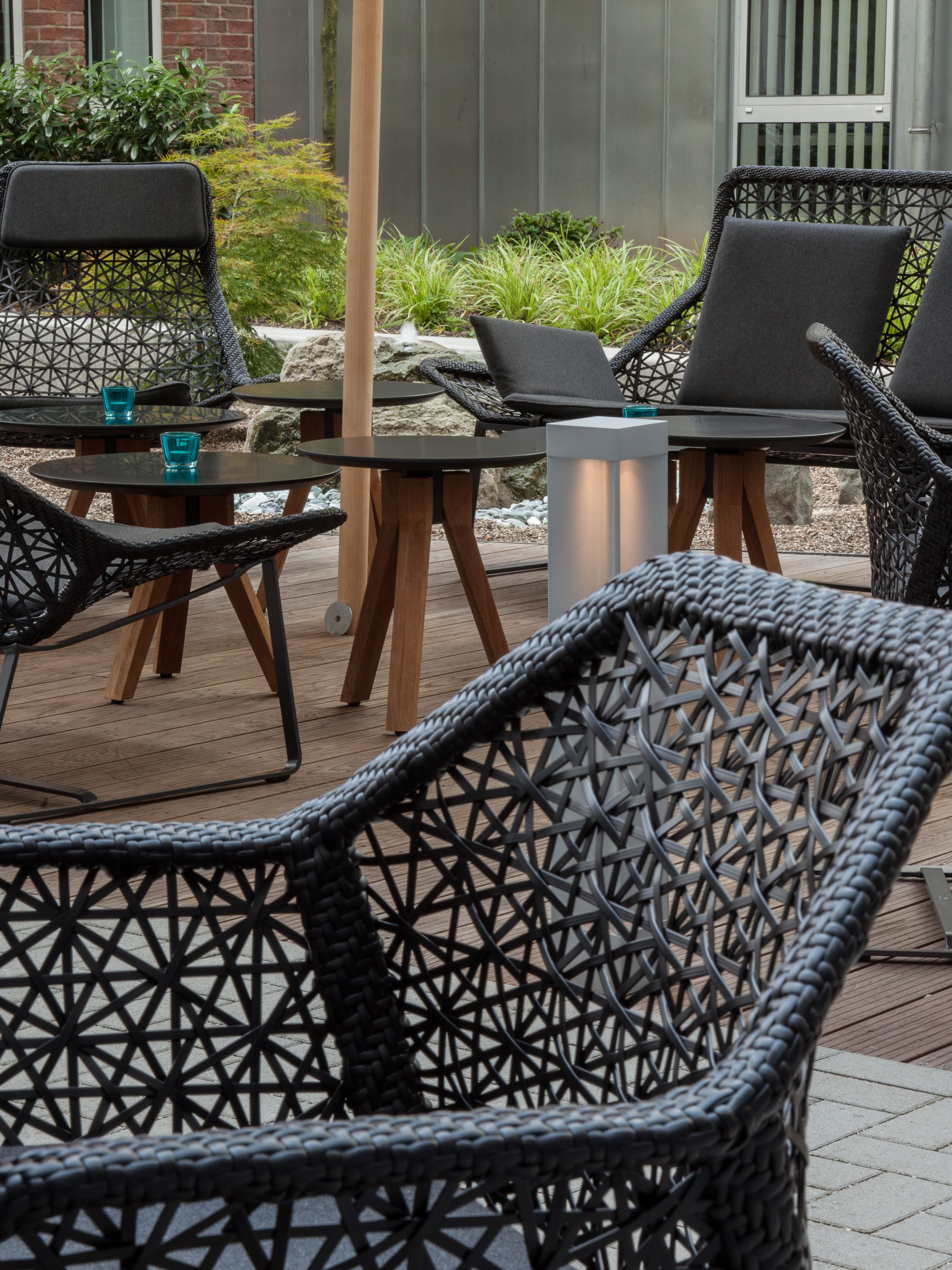 designhotel Düsseldorf Hauptbahnhof Motel One terrace with a view of several chairs and side tables