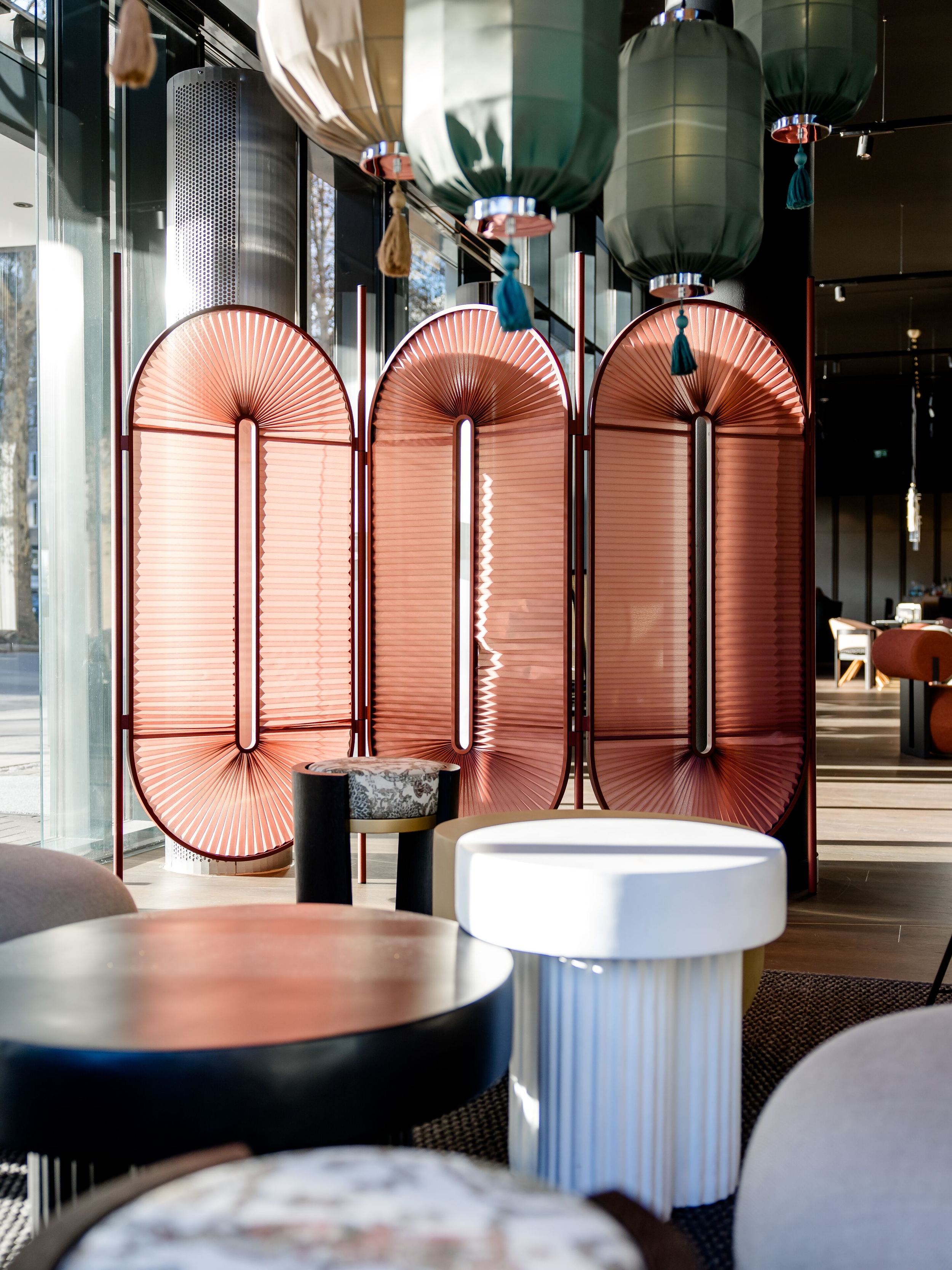 Hotel Dusseldorf Hauptbahnhof Motel One bright lounge with armchairs and room divider in pink