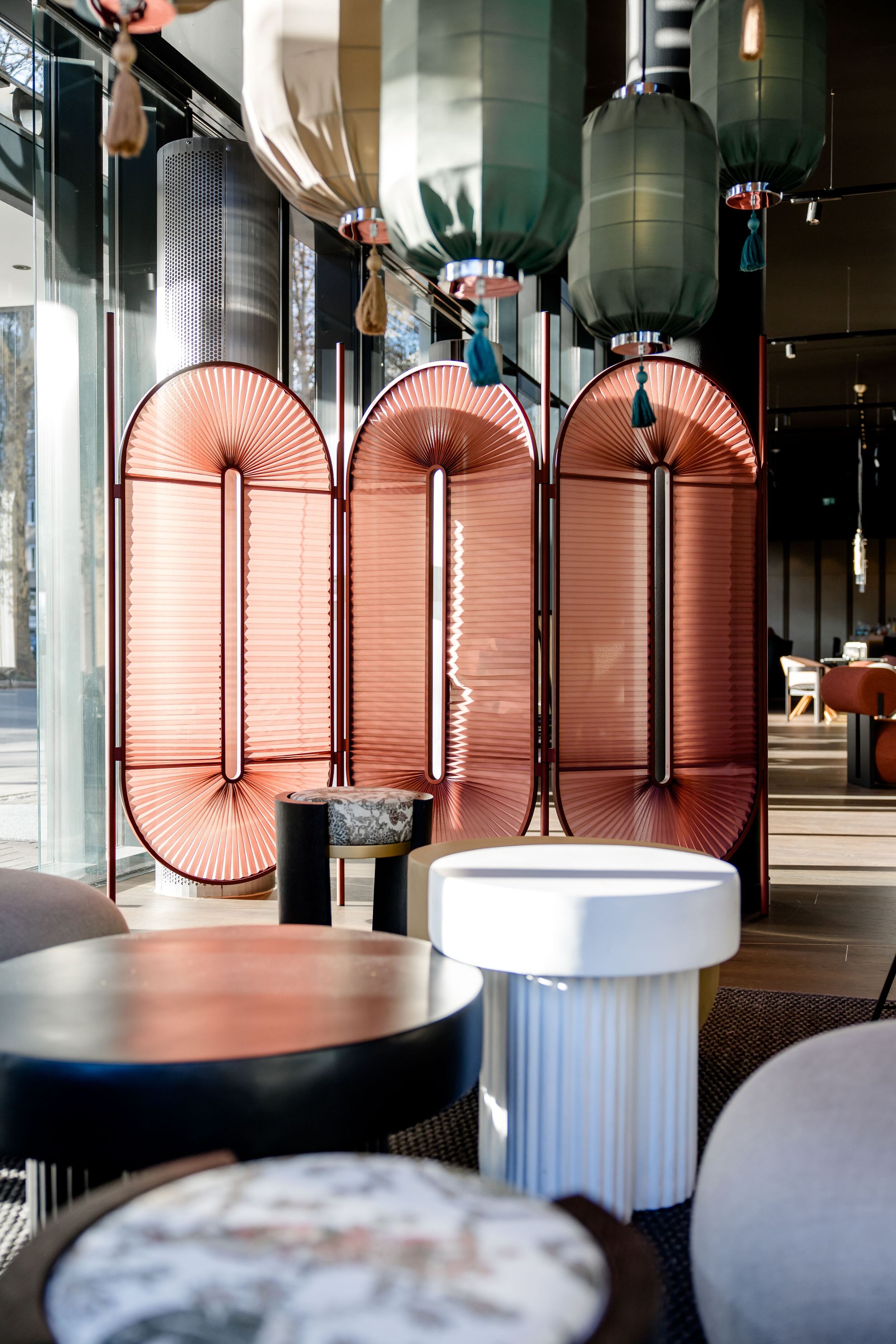 Hotel Dusseldorf Hauptbahnhof Motel One bright lounge with armchairs and room divider in pink