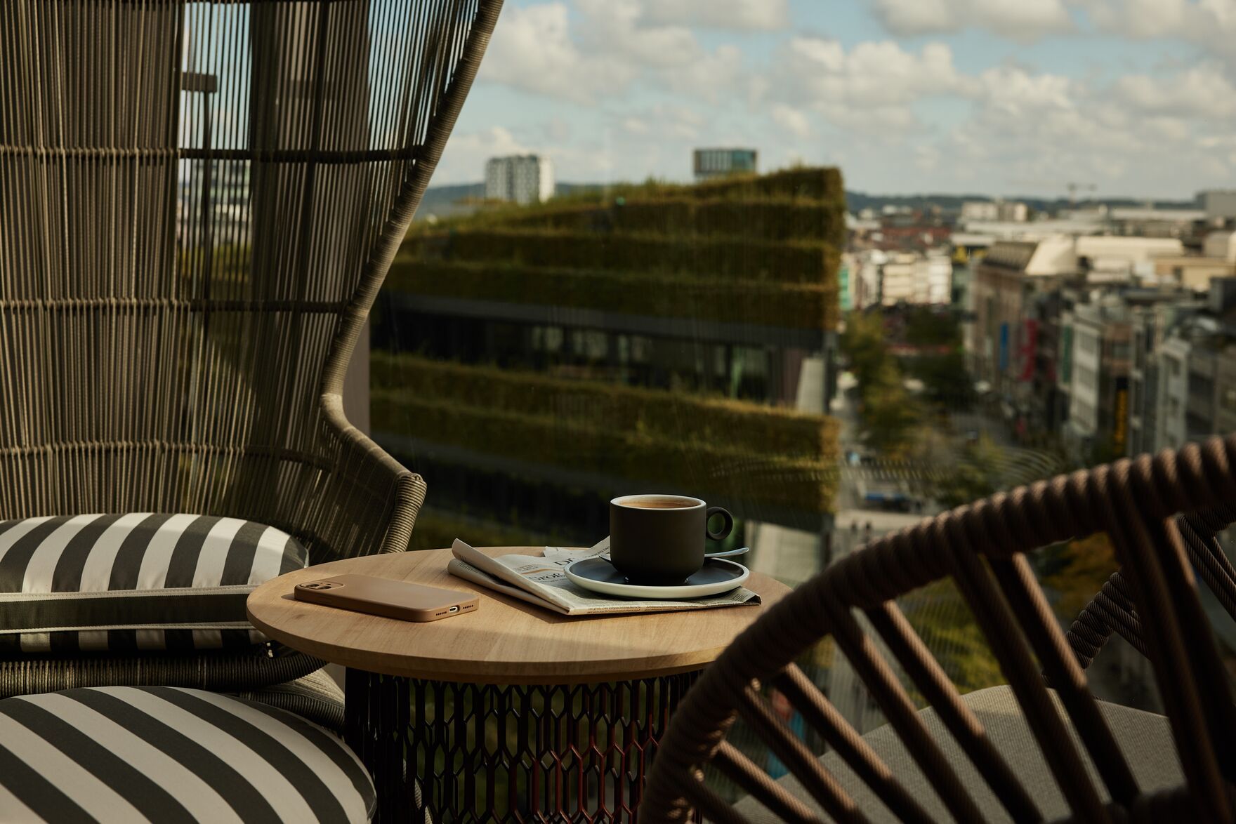 Hotel Düsseldorf KöBogen The Cloud One Nahaufnahme auf einen Tisch mit zwei großen Sesseln auf hoher Terrasse