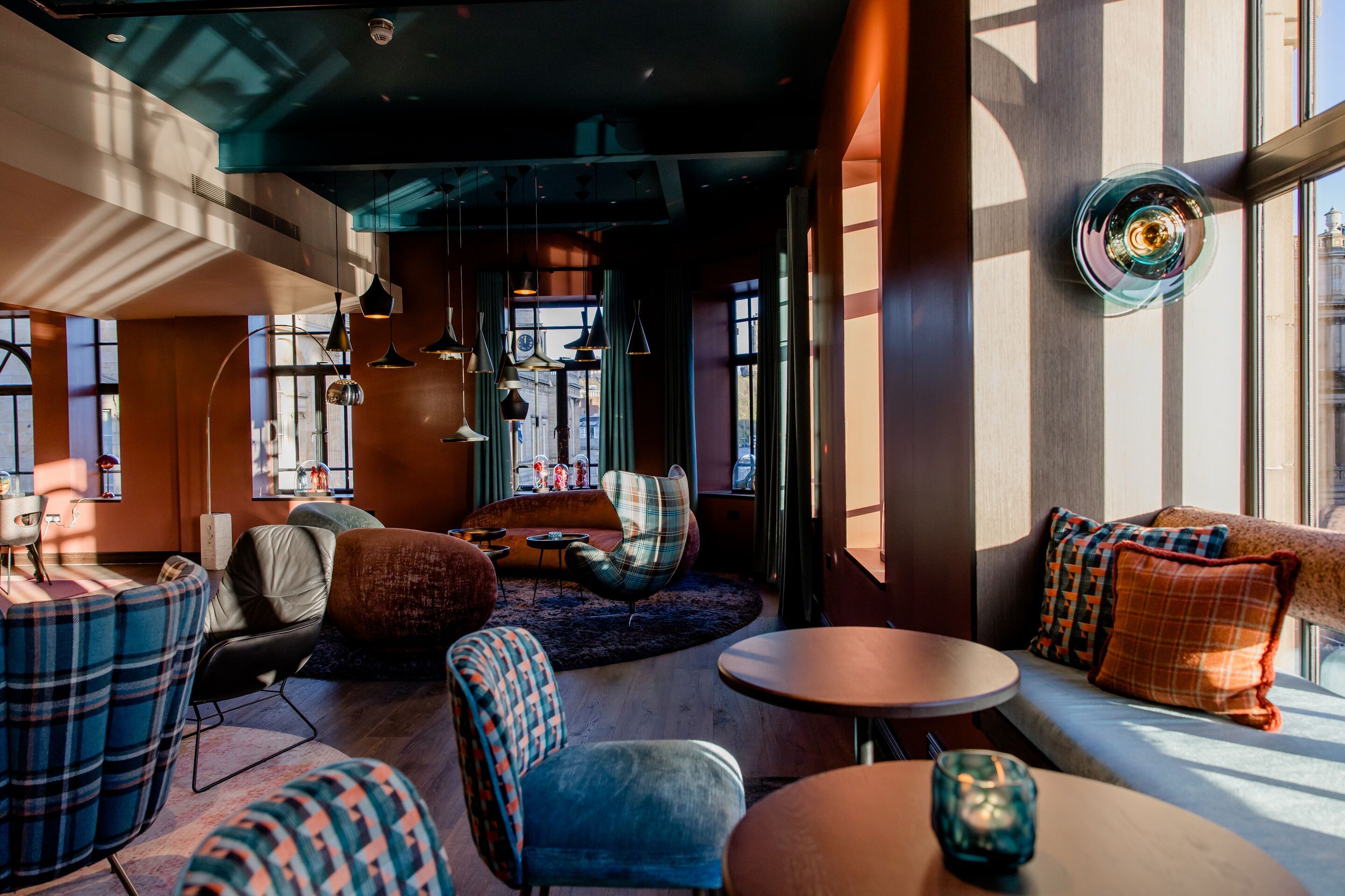 Hotel Edinburgh Princes Motel One helle Lounge mit mehreren Sitzgelegenheiten und direkter Sonneneinstrahlung durch mehrere große Fenster