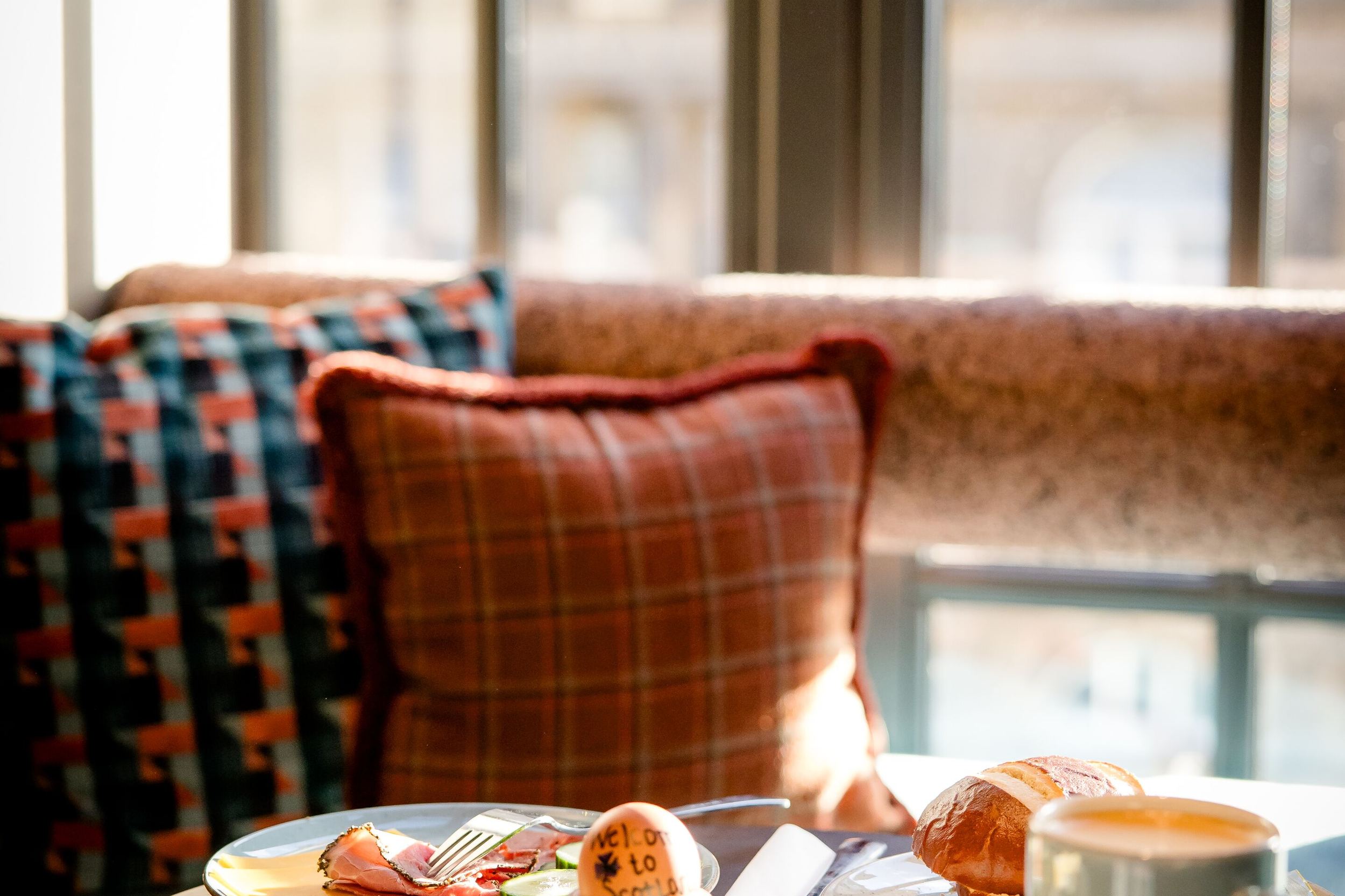 Hotel Edinburgh Princes Motel One gedeckter Frühstückstisch mit Sessel vor großem Fenster
