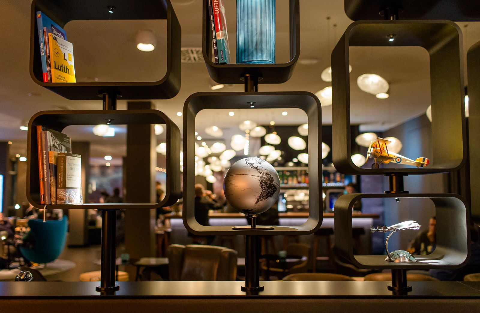 Hotel Frankfurt Airport Motel One Blick auf ein großes offenes Regal mit Dekoration passend zum Thema Flughafen