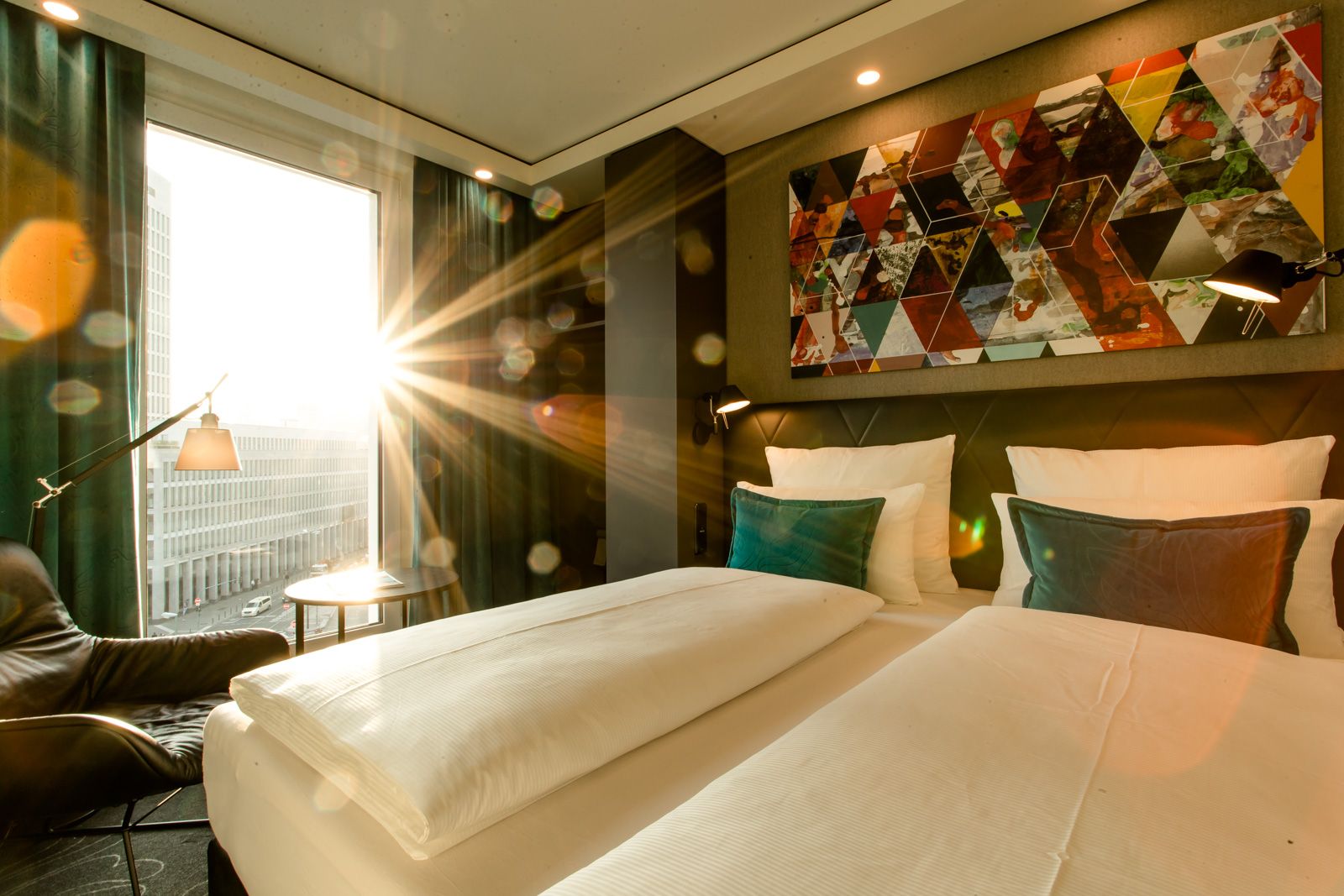 Hotel Frankfurt Römer Motel One Zimmer mit Doppelbett und direkter Sonneneinstrahlung durch bodentiefes Fenster