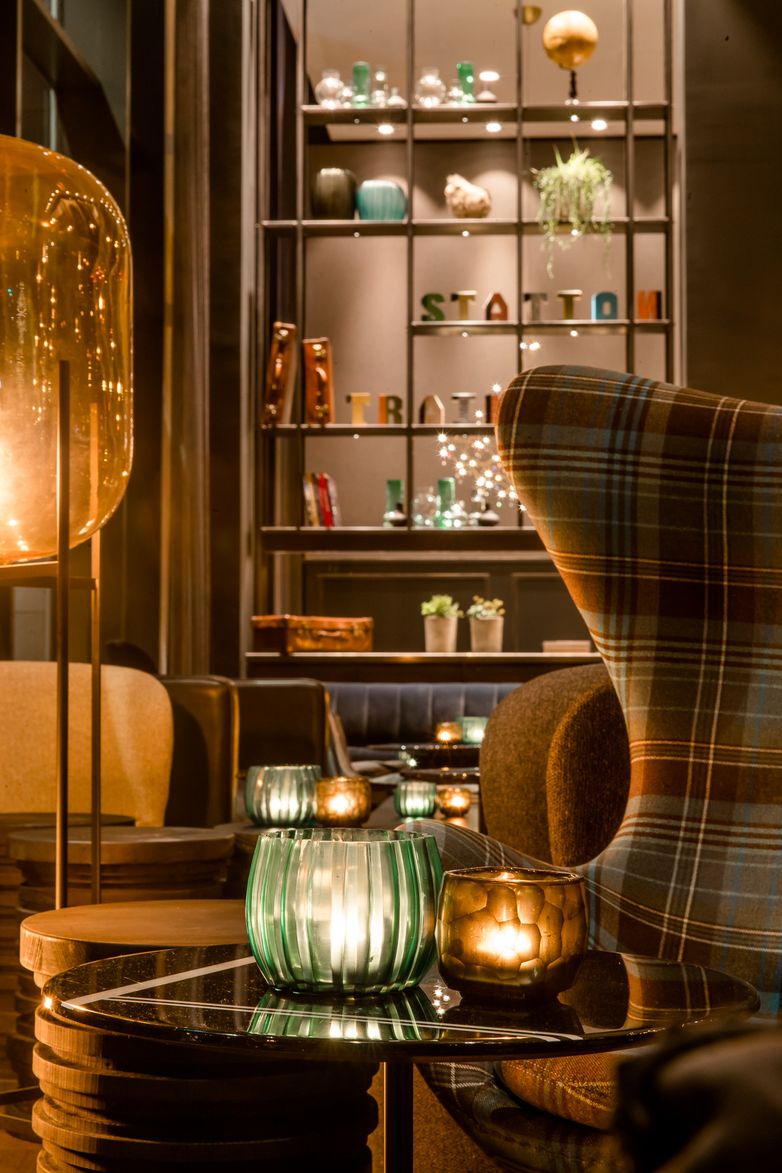 hotel Glasgow Motel One lounge with close-up of side table with candles and egg chair