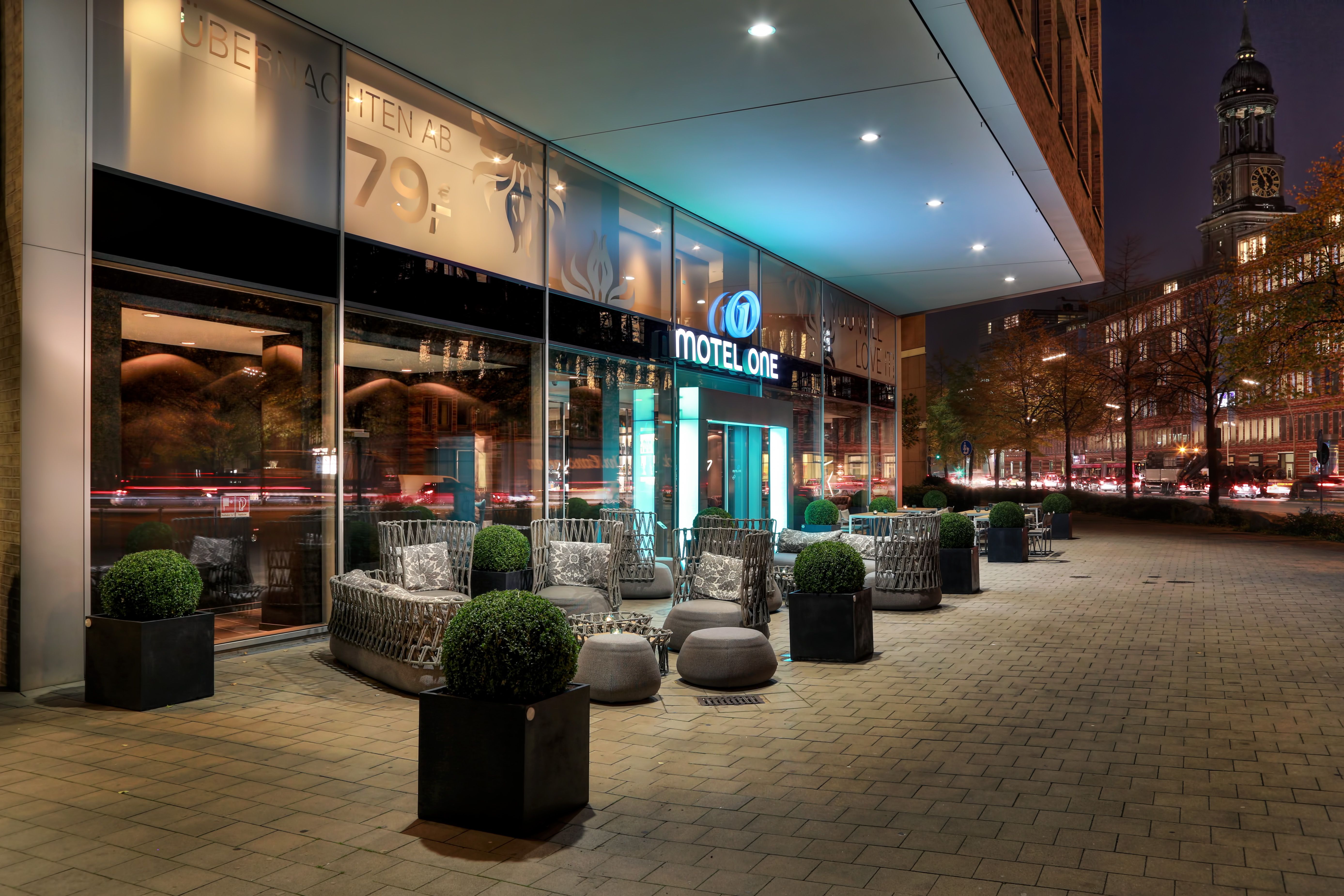 hotel Hamburg am Michel Motel One entrance area in the evening with seating