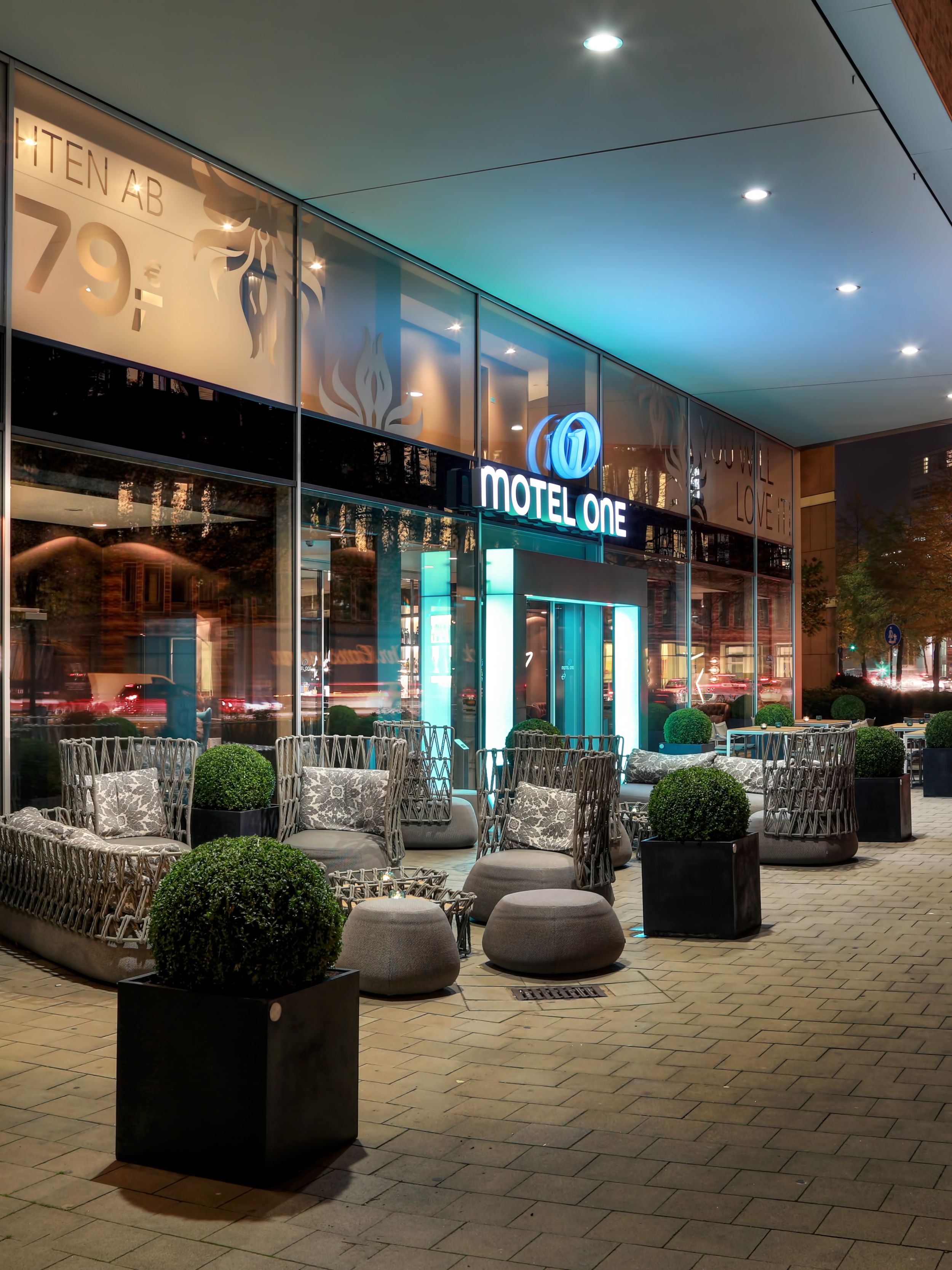 hotel Hamburg am Michel Motel One entrance area in the evening with seating
