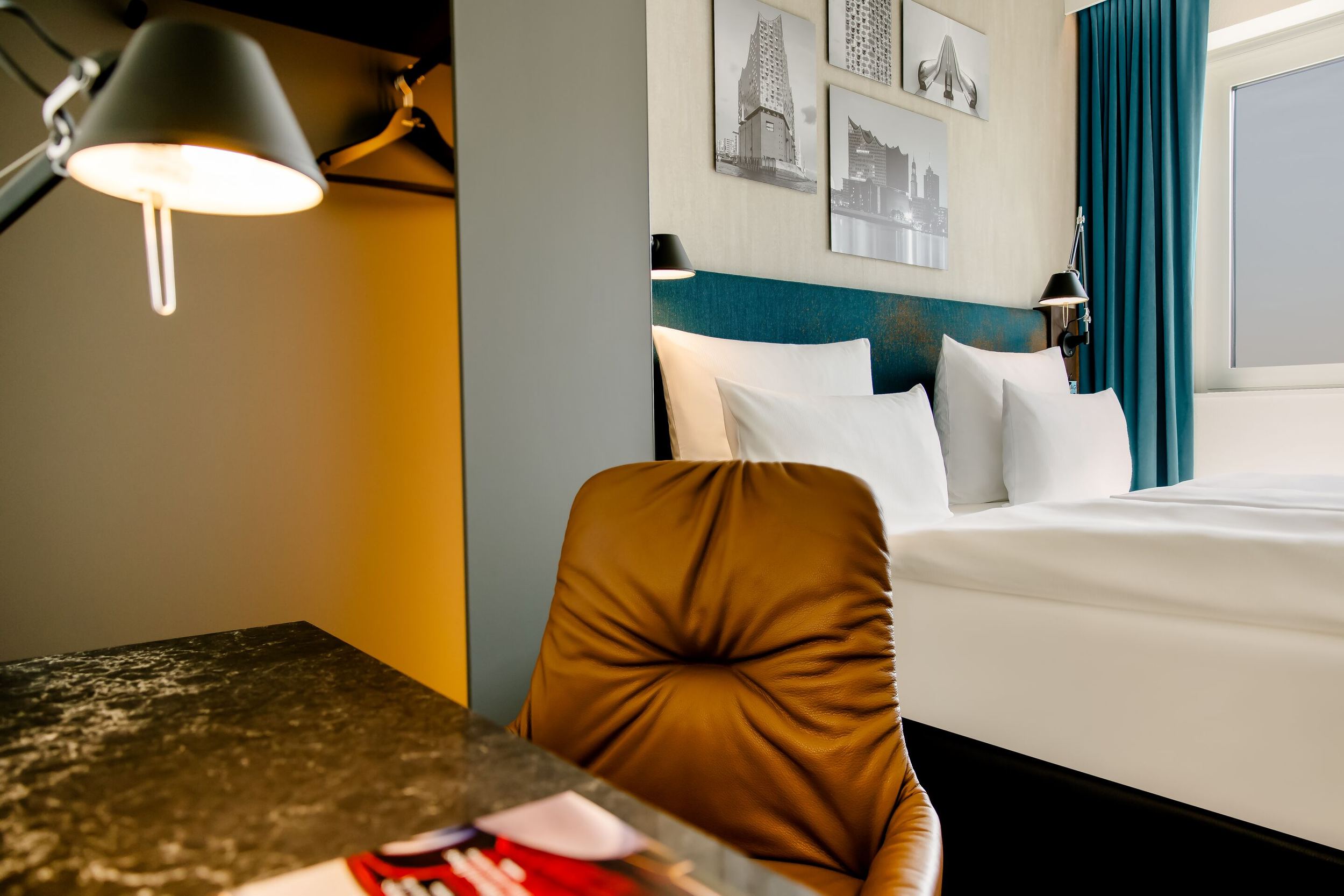 Hotel Hamburg am Michel Motel One Zimmer mit Doppelbett sowie Schreibtisch und Sessel