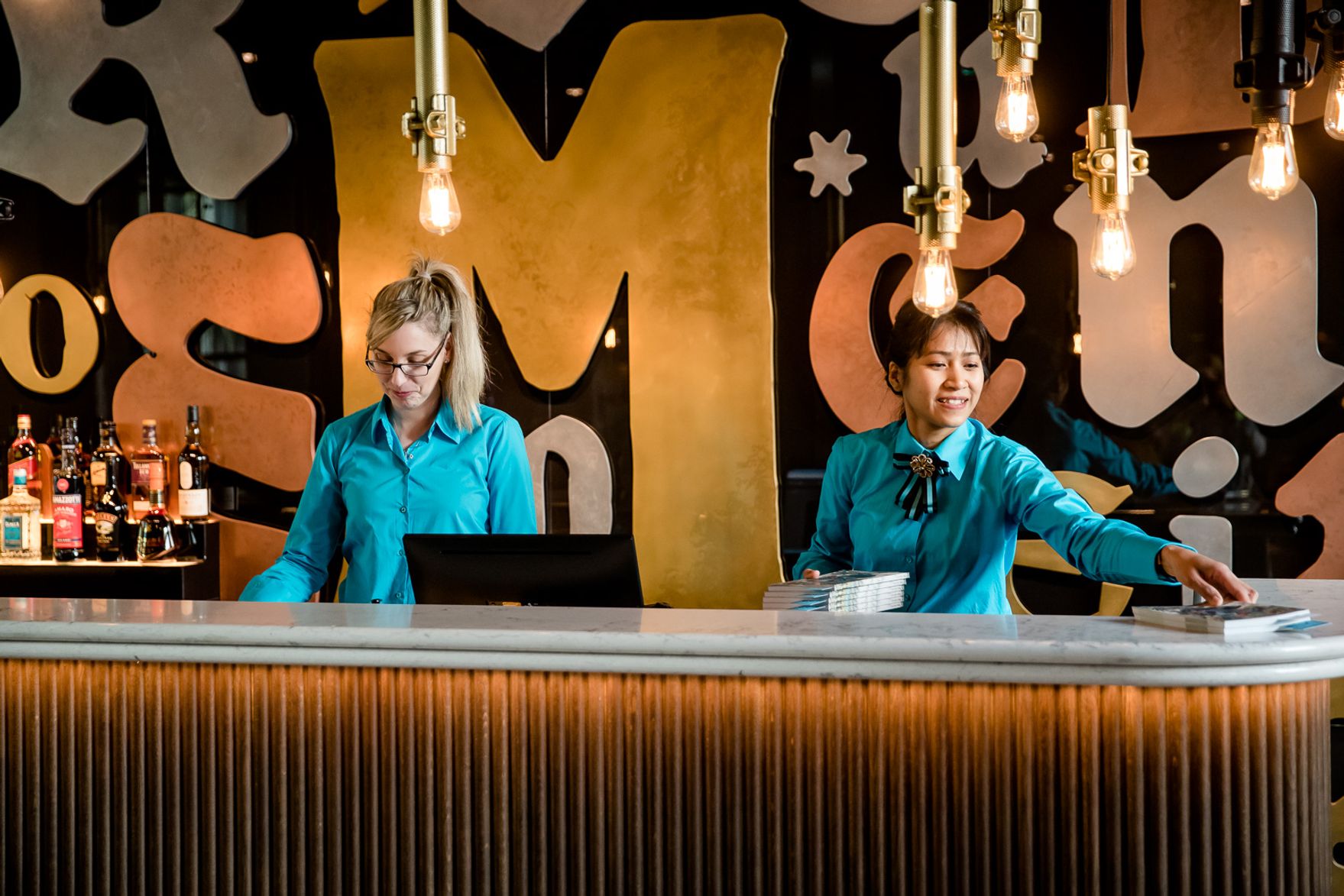 designhotel Hanover Oper Motel One reception with two employees
