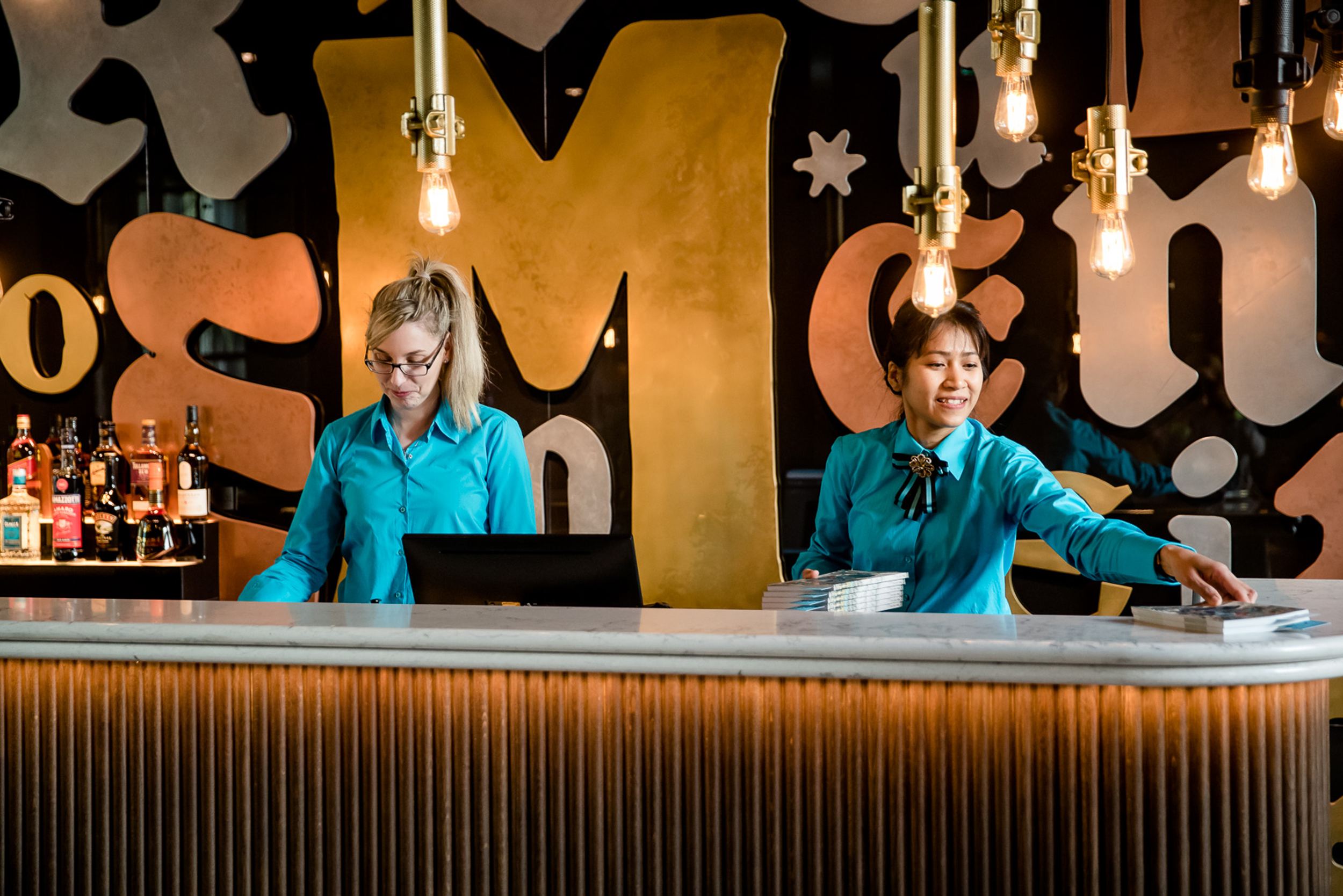 Designhotel Hannover Oper Motel One Rezeption mit zwei Mitarbeiterinnen