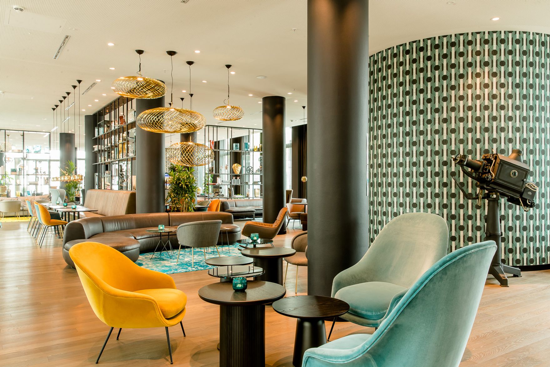 Hotel Köln Messe Motel One lichtdurchflutete Lounge mit mehreren farbigen Sesseln