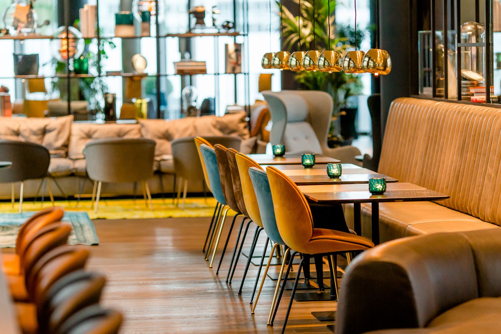 Designhotel Köln Messe Motel One heller Raum mit mehreren Tischen und Stühlen