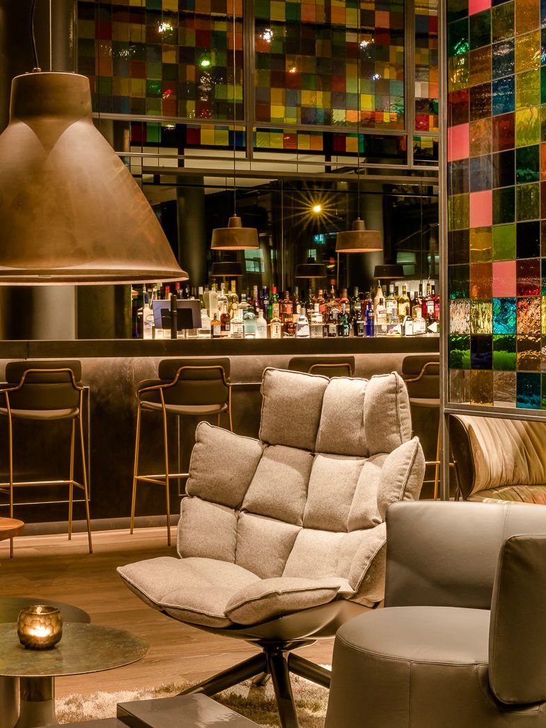 Hotel Cologne Neumarkt Motel One armchair in the foreground and bar in the background