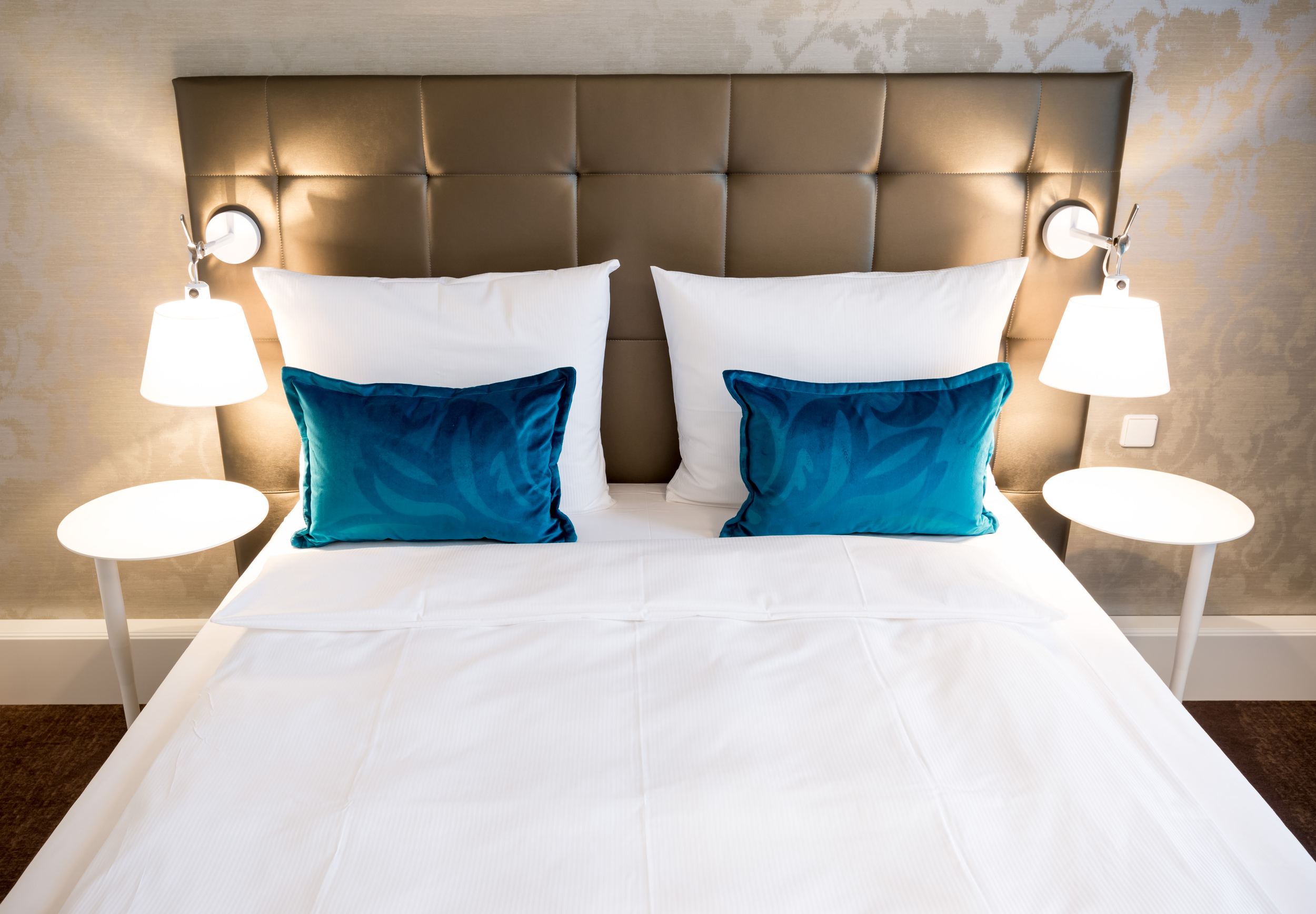 Hotel Magdeburg Motel One Blick auf komfortables Doppelbett mit zwei Zierkissen in türkis
