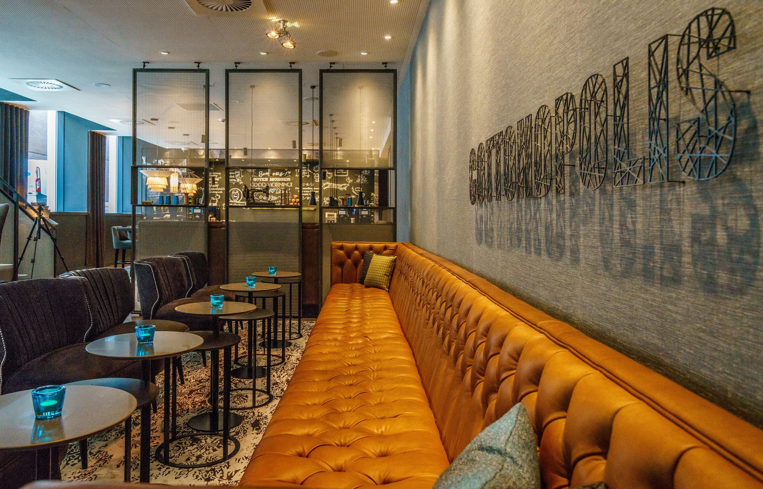 hotel Manchester Royal Exchange Motel One long couch with tables and chairs