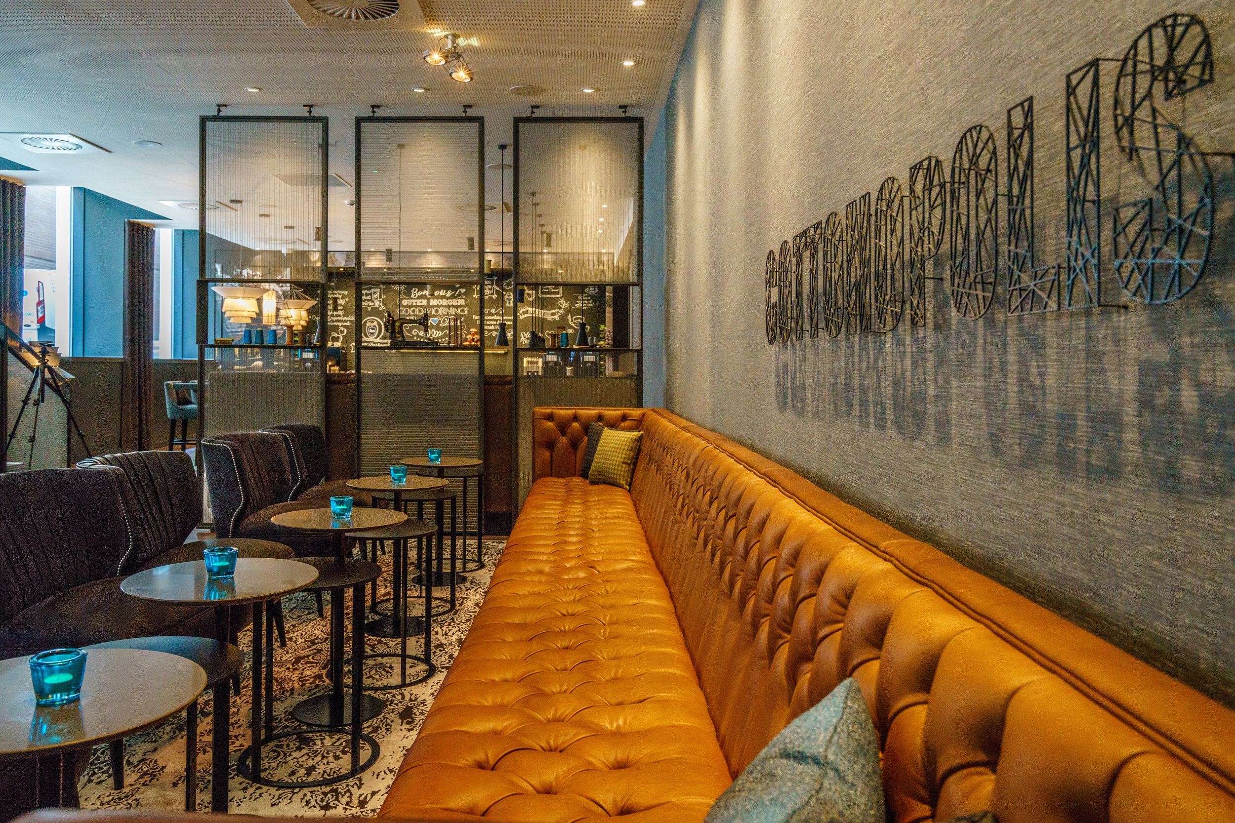 hotel Manchester Royal Exchange Motel One long couch with tables and chairs