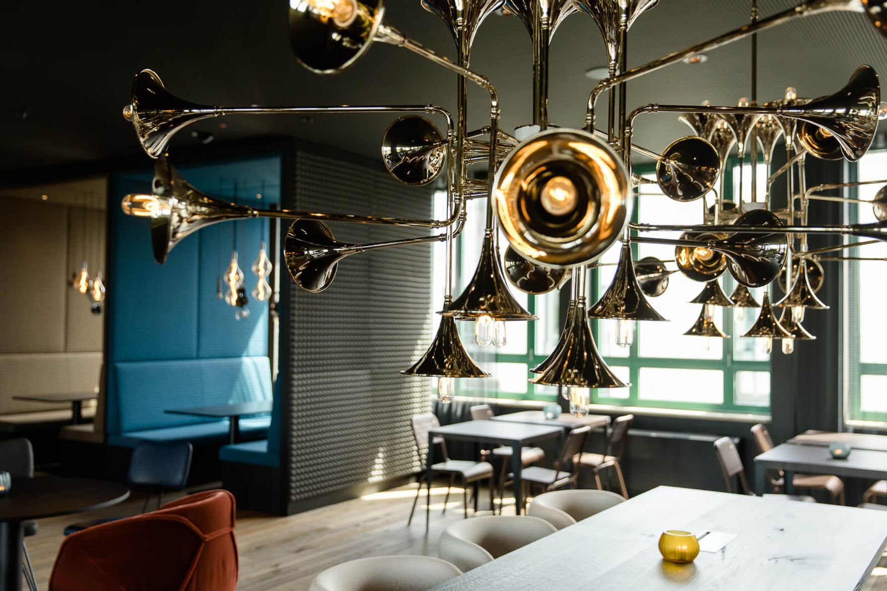 hotel Mannheim Motel One lounge with seating and trumpet lamp