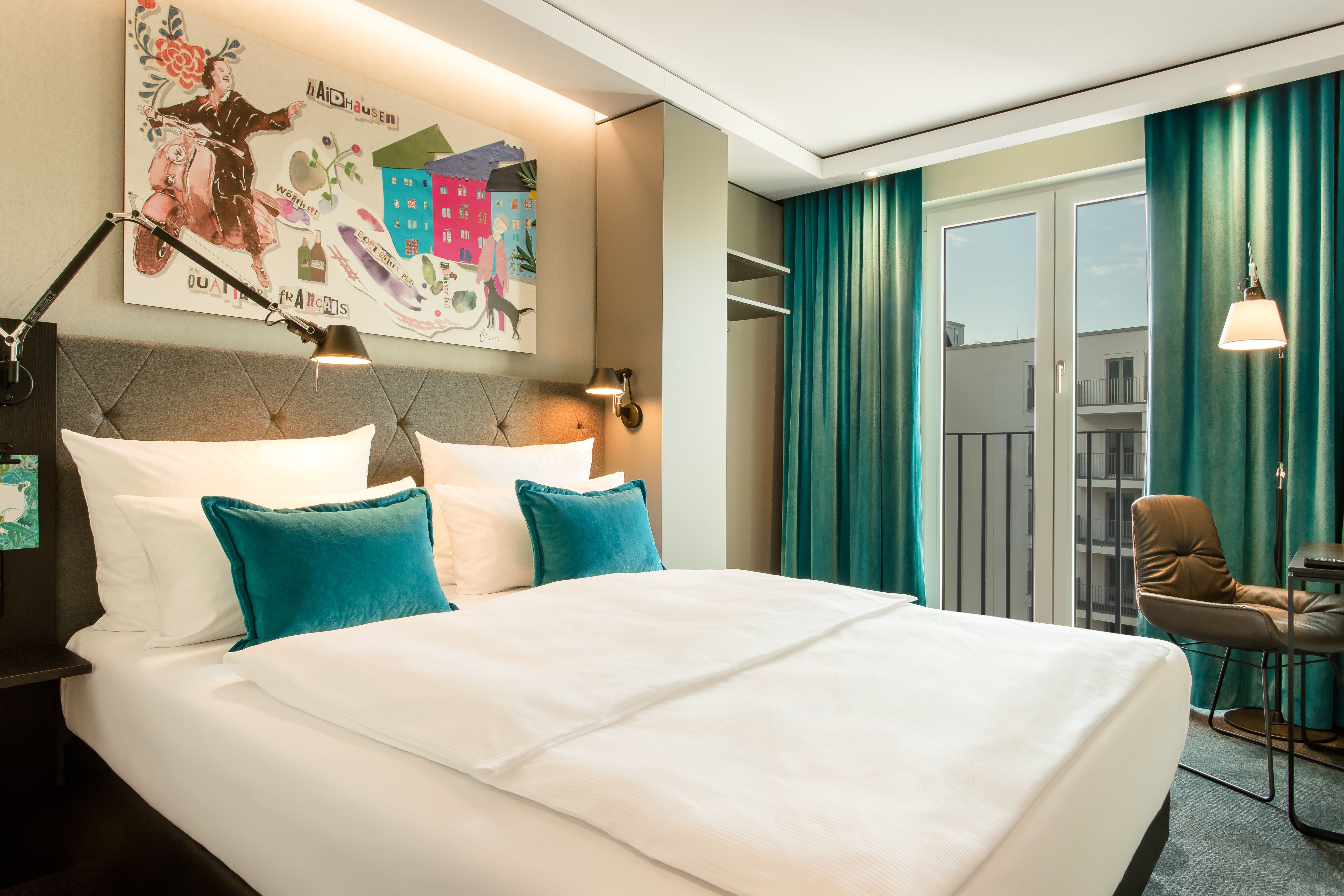Designhotel München Haidhausen Motel One Doppelbett mit bodentiefen Fenstern sowie Stuhl