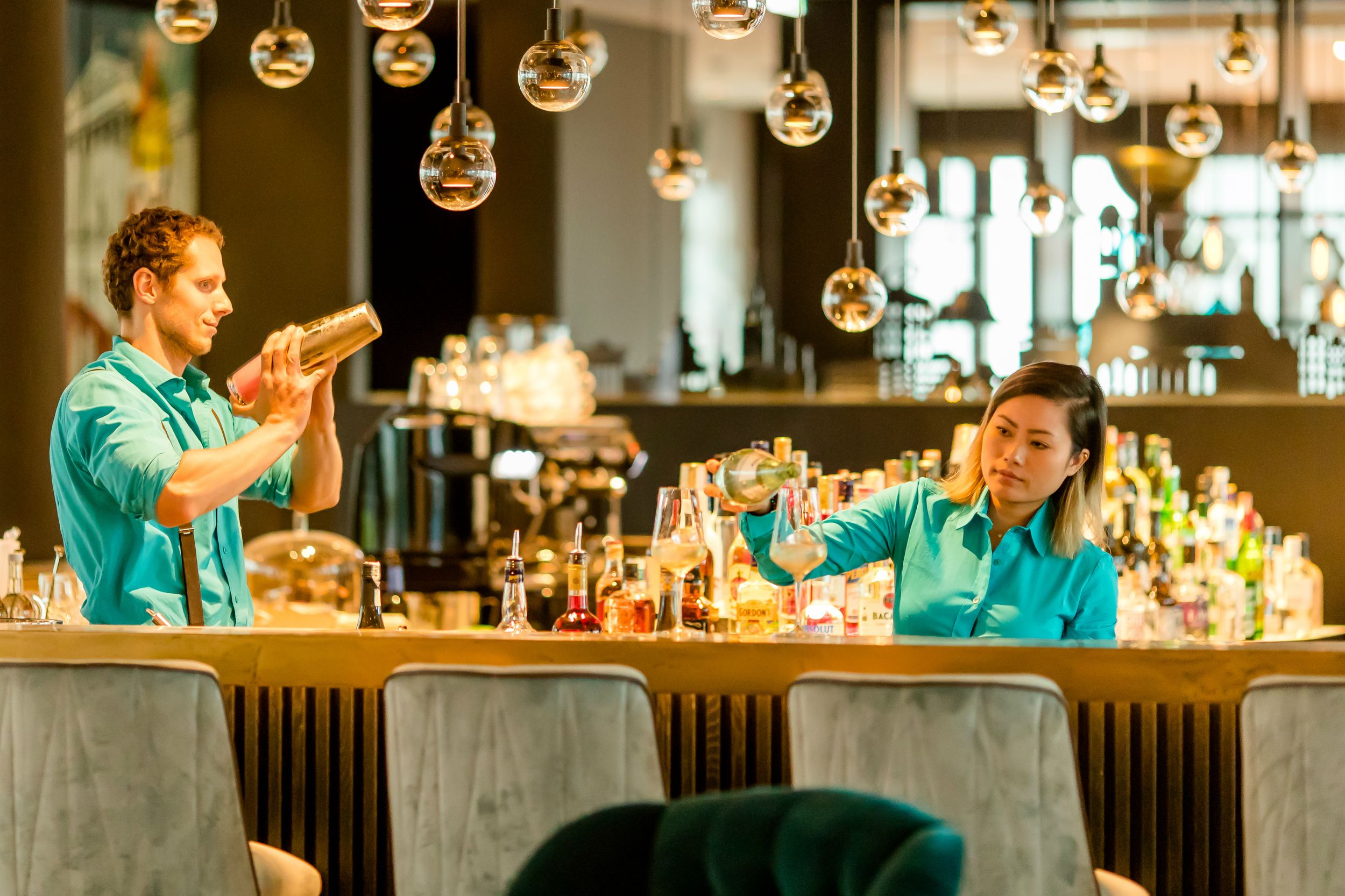 Designhotel München Messe Motel One Bar mit zwei Mitarbeitenden bei der Arbeit