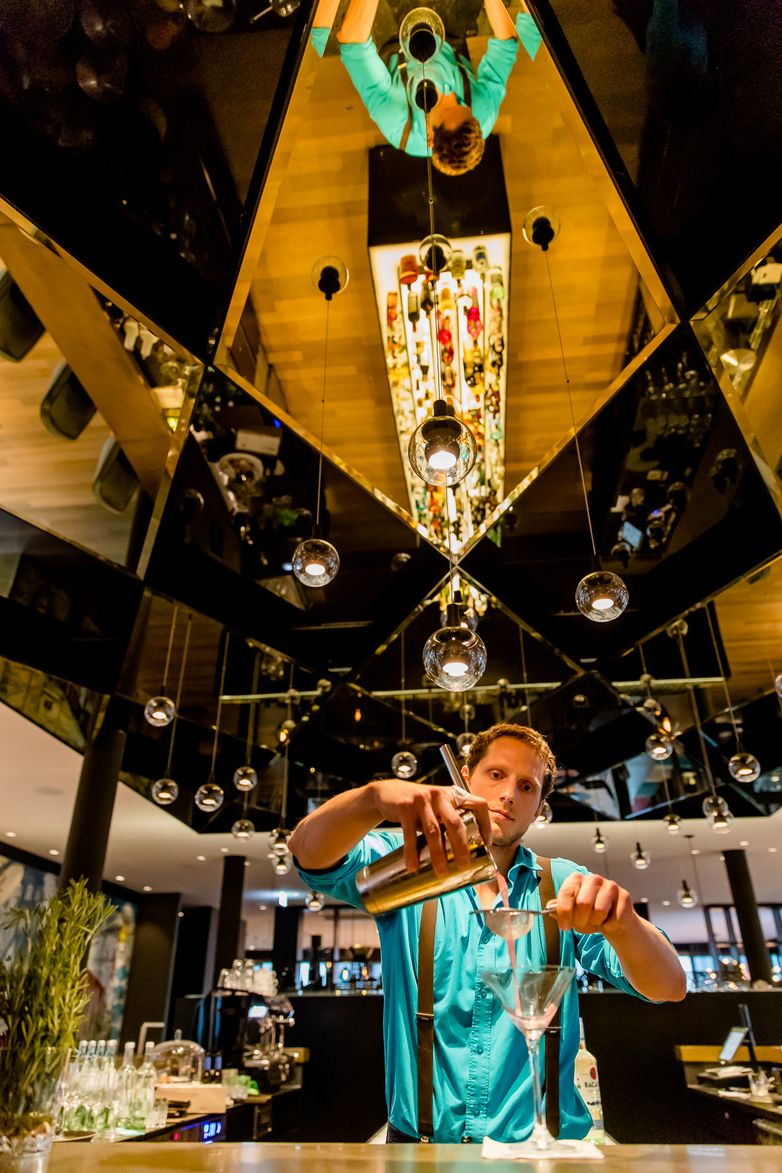 Hotel Munich Trade Fair Motel One bartender prepares a drink at the bar