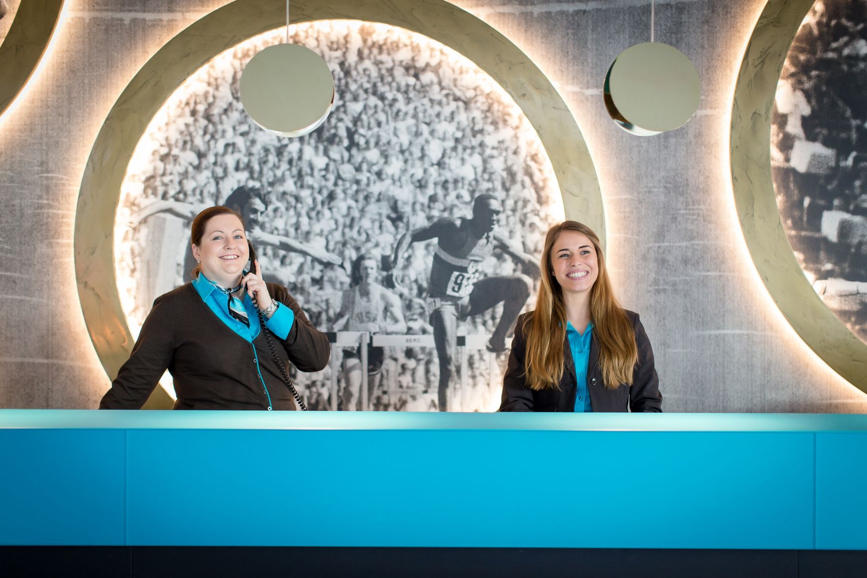 hotel Munich Olympia Gate Motel One reception with two smiling employees