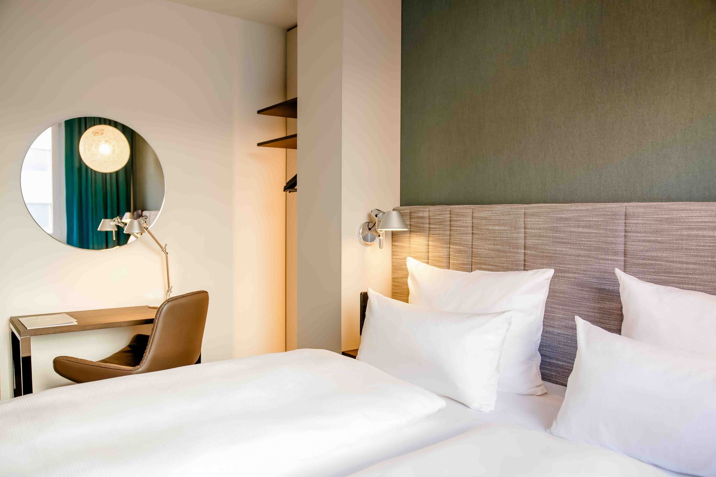 Designhotel Nürnberg City Motel One Zimmer mit Doppelbett sowie Schreibtisch und Sessel