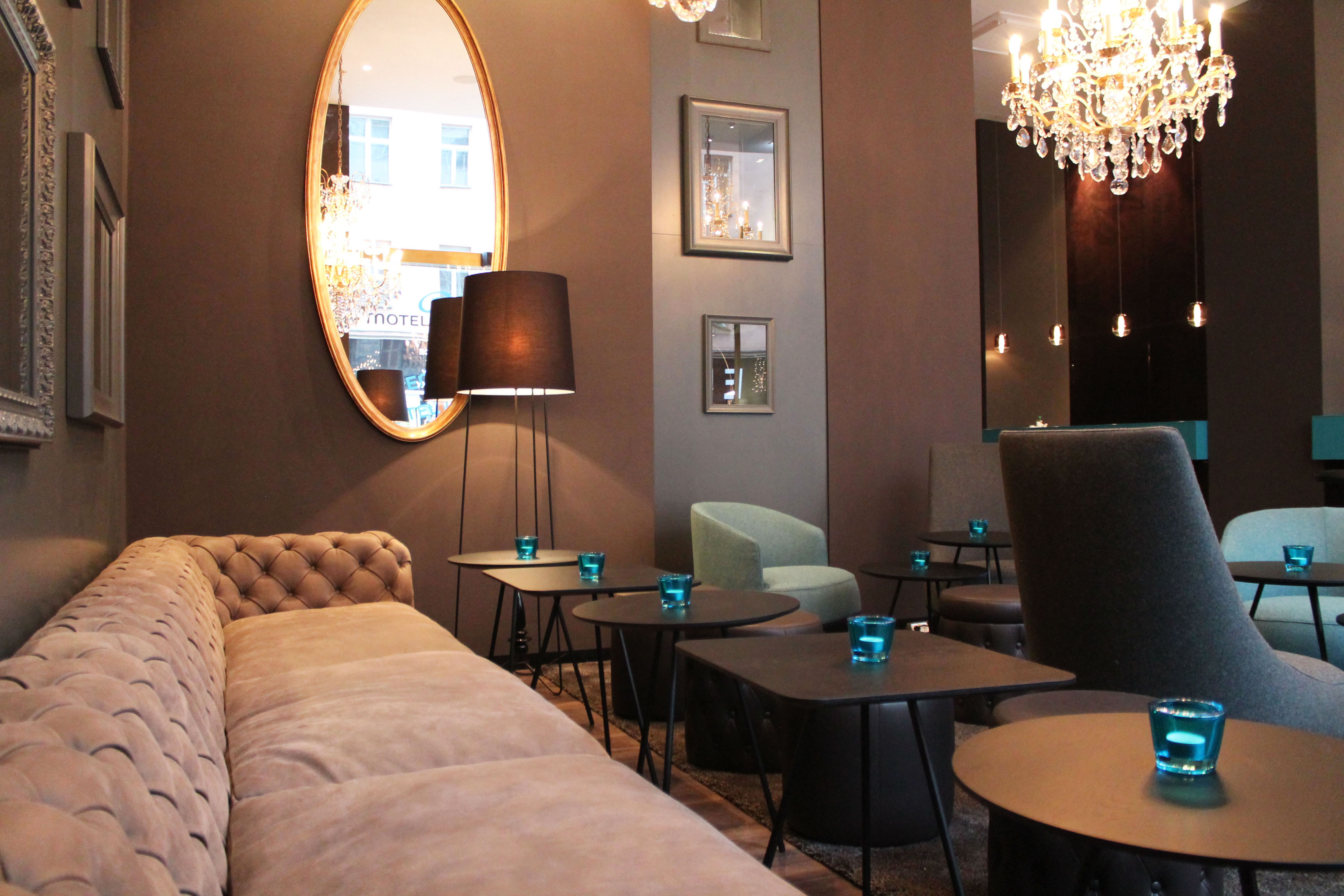hotel Prague Florentinum Motel One lounge with large sofa, tables and mirror on the wall hotel Prague Florentinum Motel One lounge with large sofa, tables and mirror on the wall