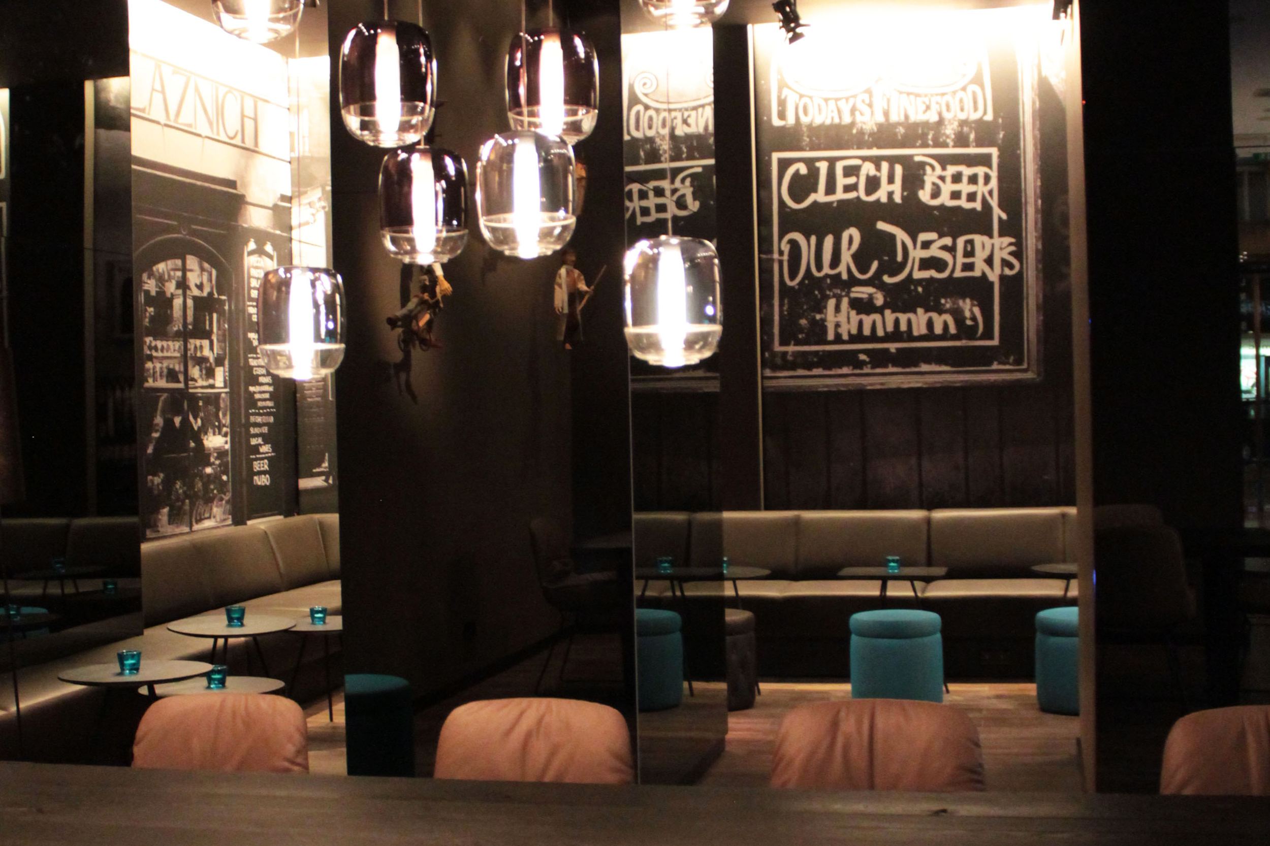 hotel Prague Florentinum Motel One indoor lounge area with tables and chairs