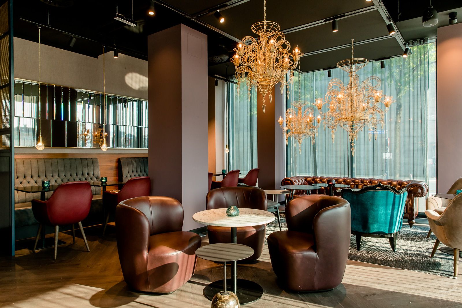 Designhotel Salzburg Mirabell Motel One Lounge mit mehreren Sitzgelegenheiten und Tischen