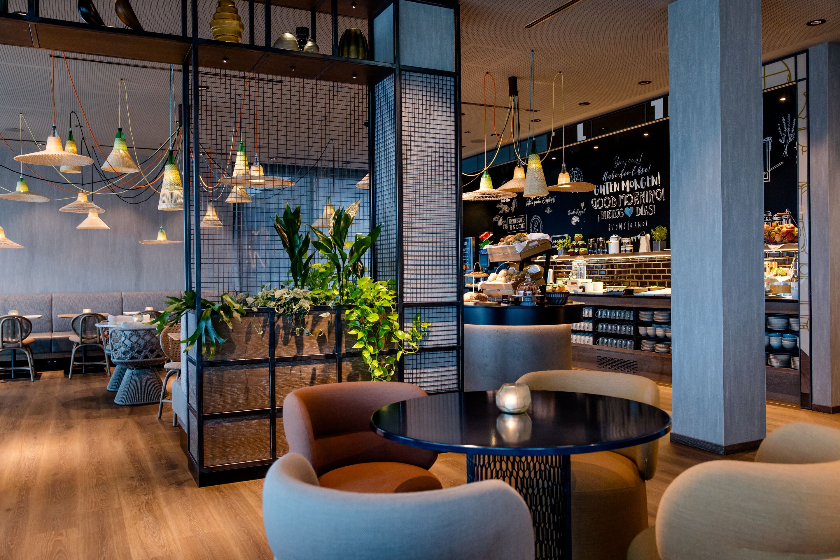 Hotel Vienna Donau City Motel One breakfast area with several seating options and buffet in the background