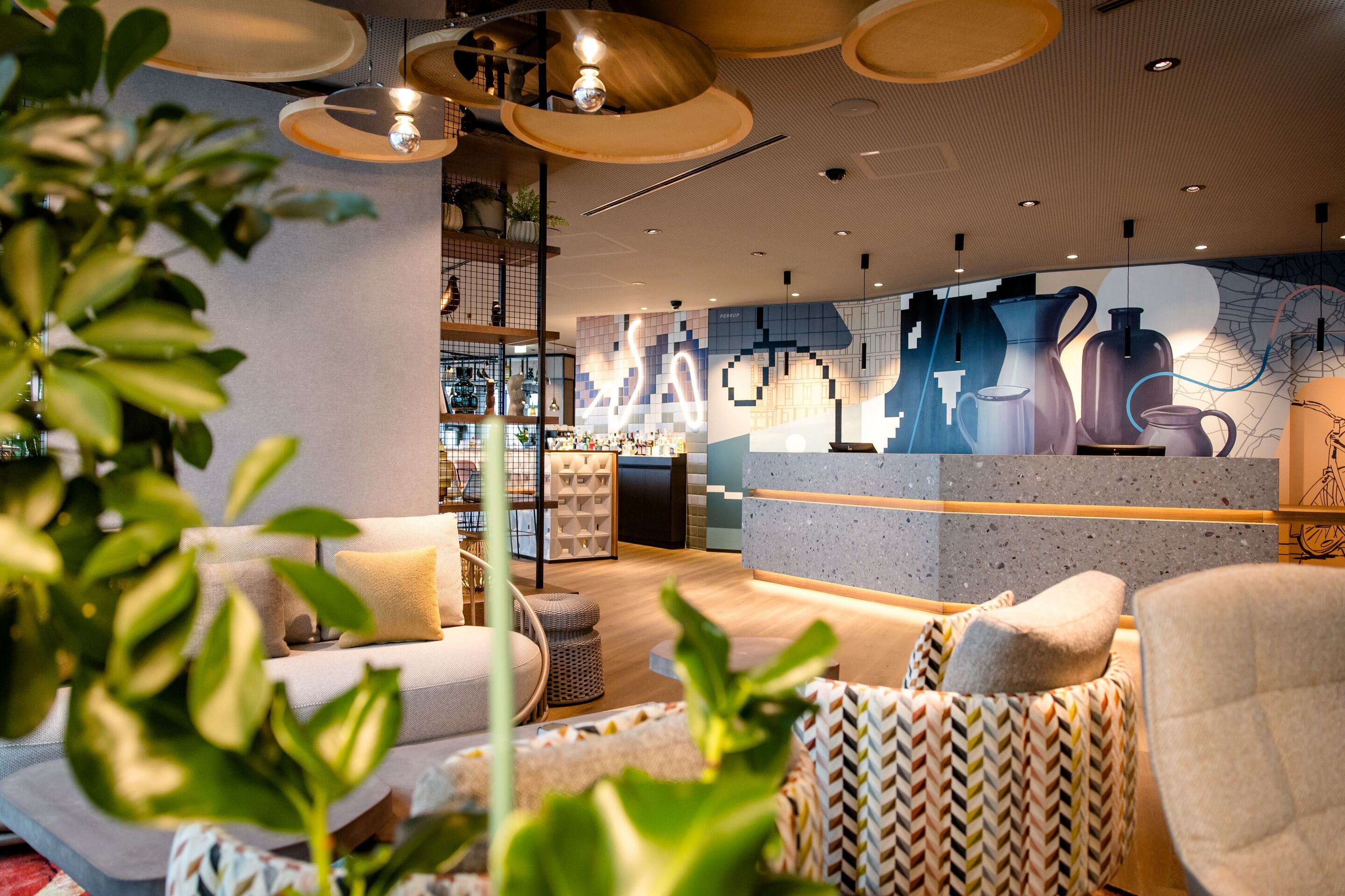 Hotel Vienna Donau City Motel One reception and lounge, with a view of the bar in the background