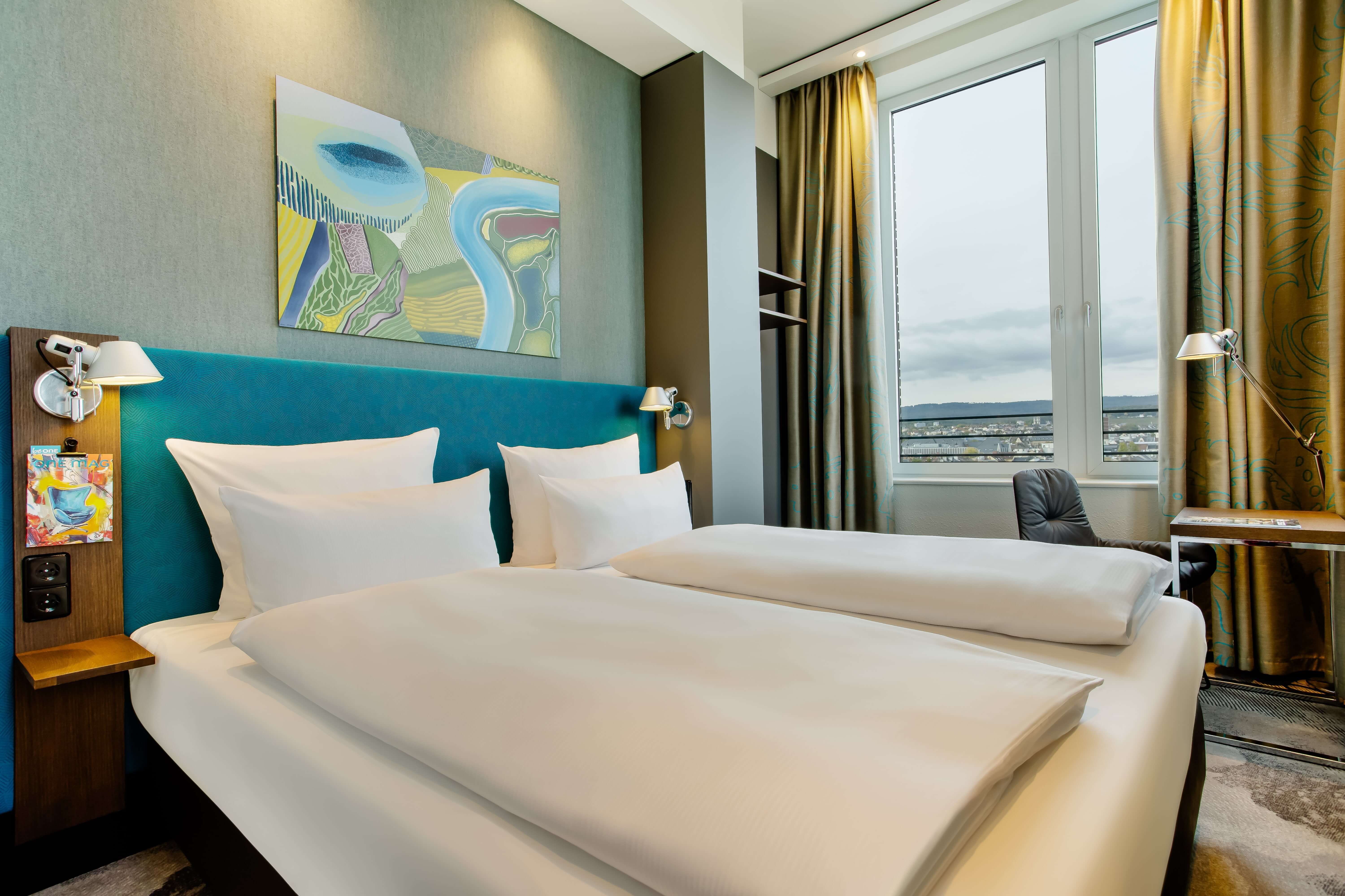 Hotel Wiesbaden Motel One lichtdurchflutetes Hotelzimmer mit Bett