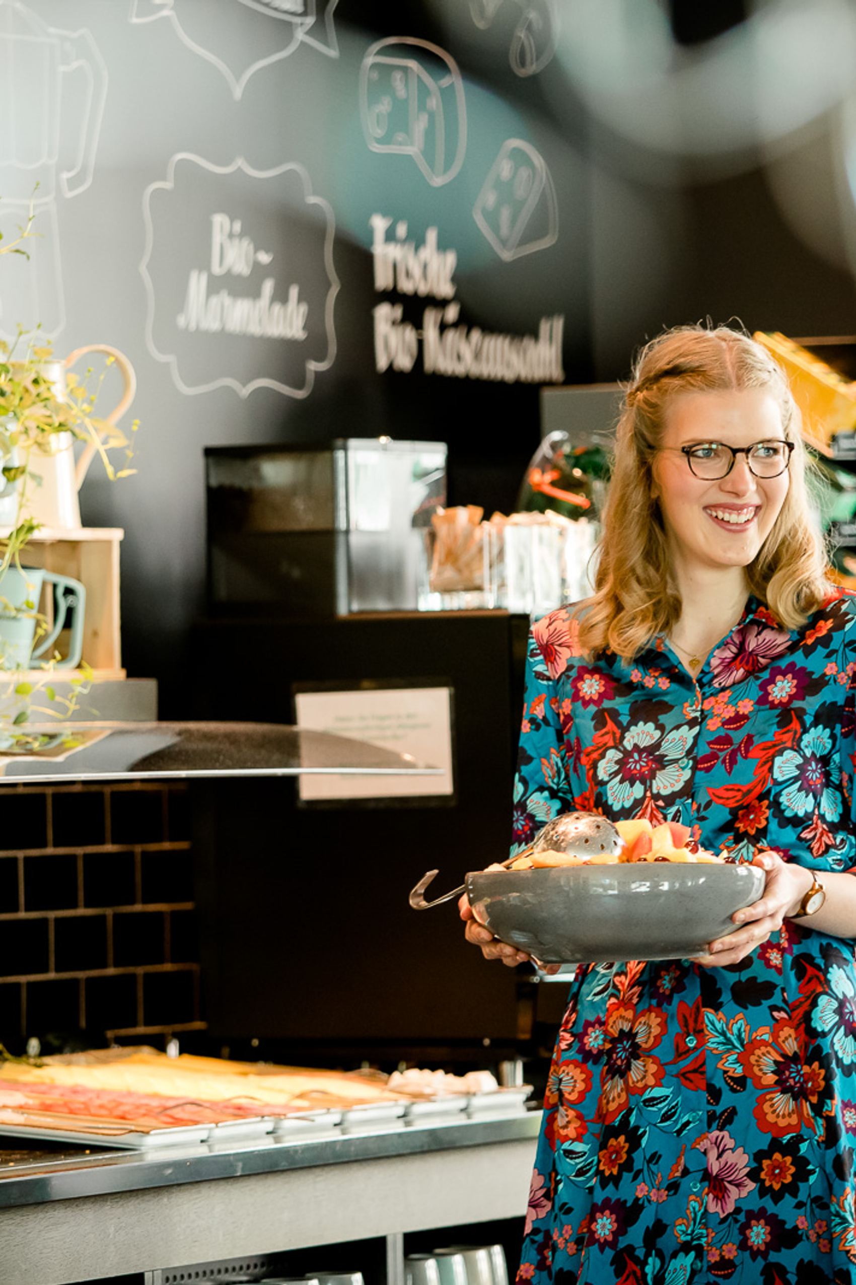 Motel One service employee working in breakfast service