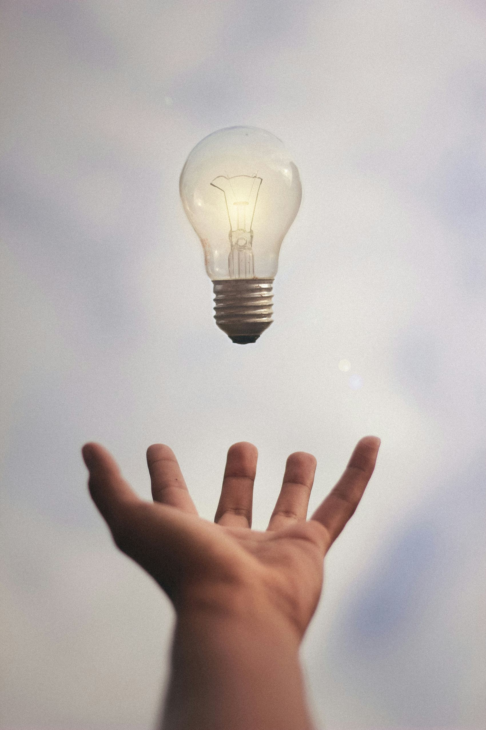 Hand with light bulb