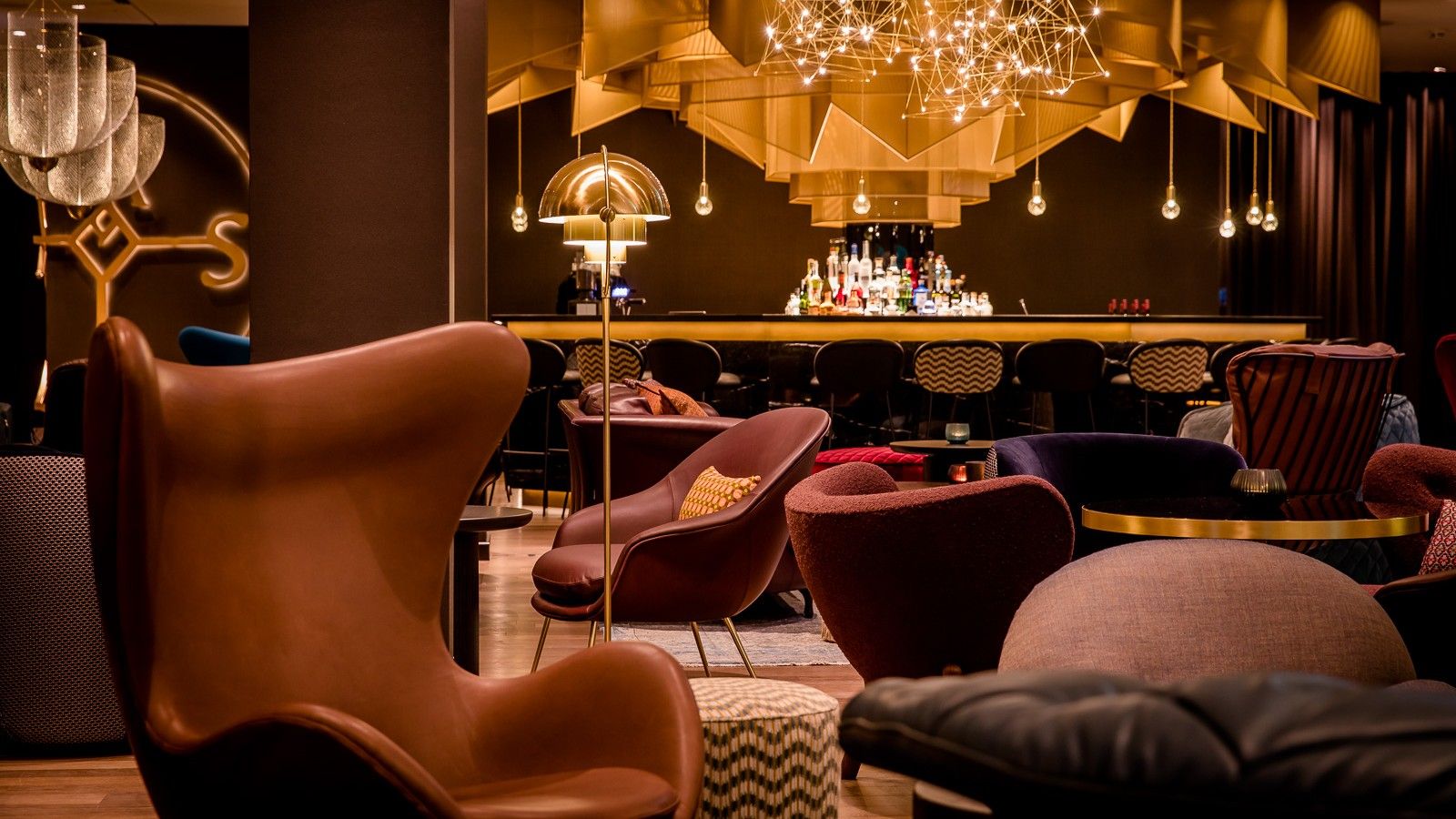 Stilvolle Motel One Hotelbar mit elegantem, gemütlichem Interieur, bequemen Sesseln und warmer Beleuchtung