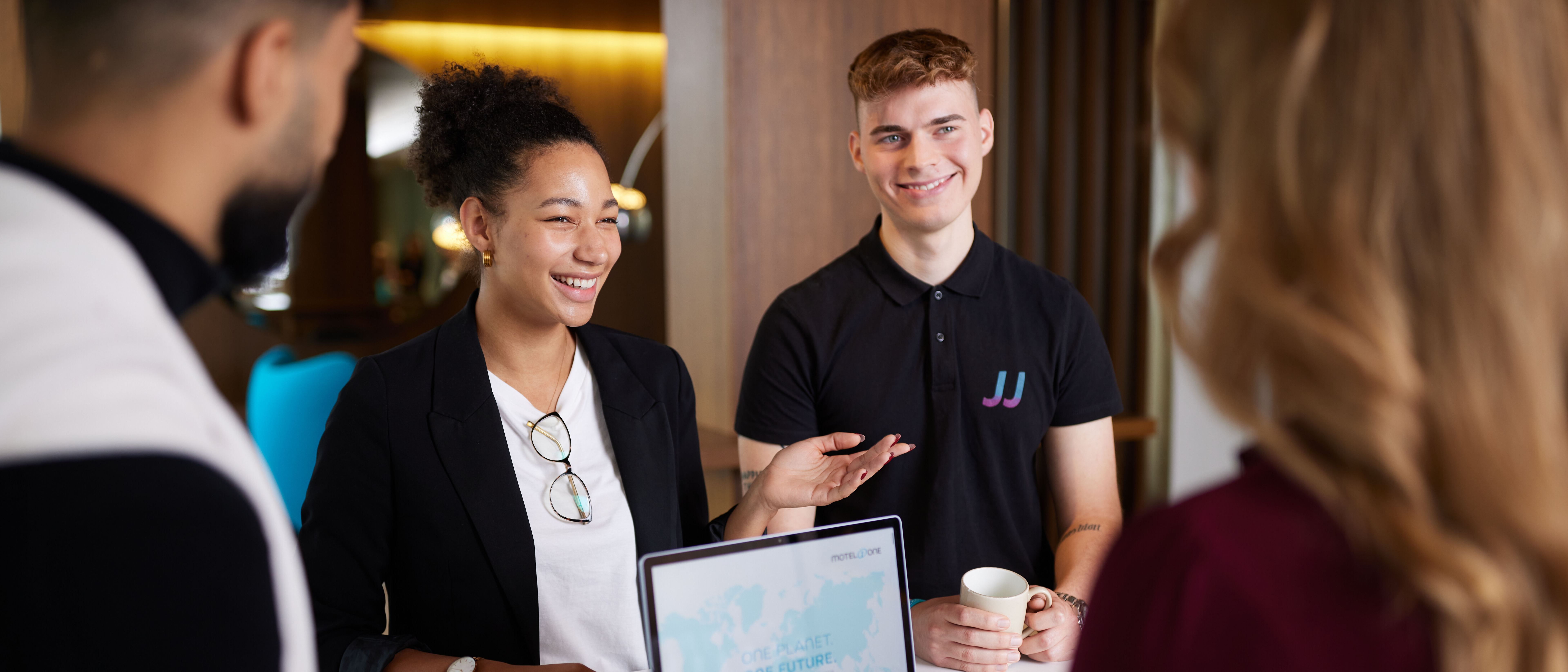 Motel One employees group talking to each other