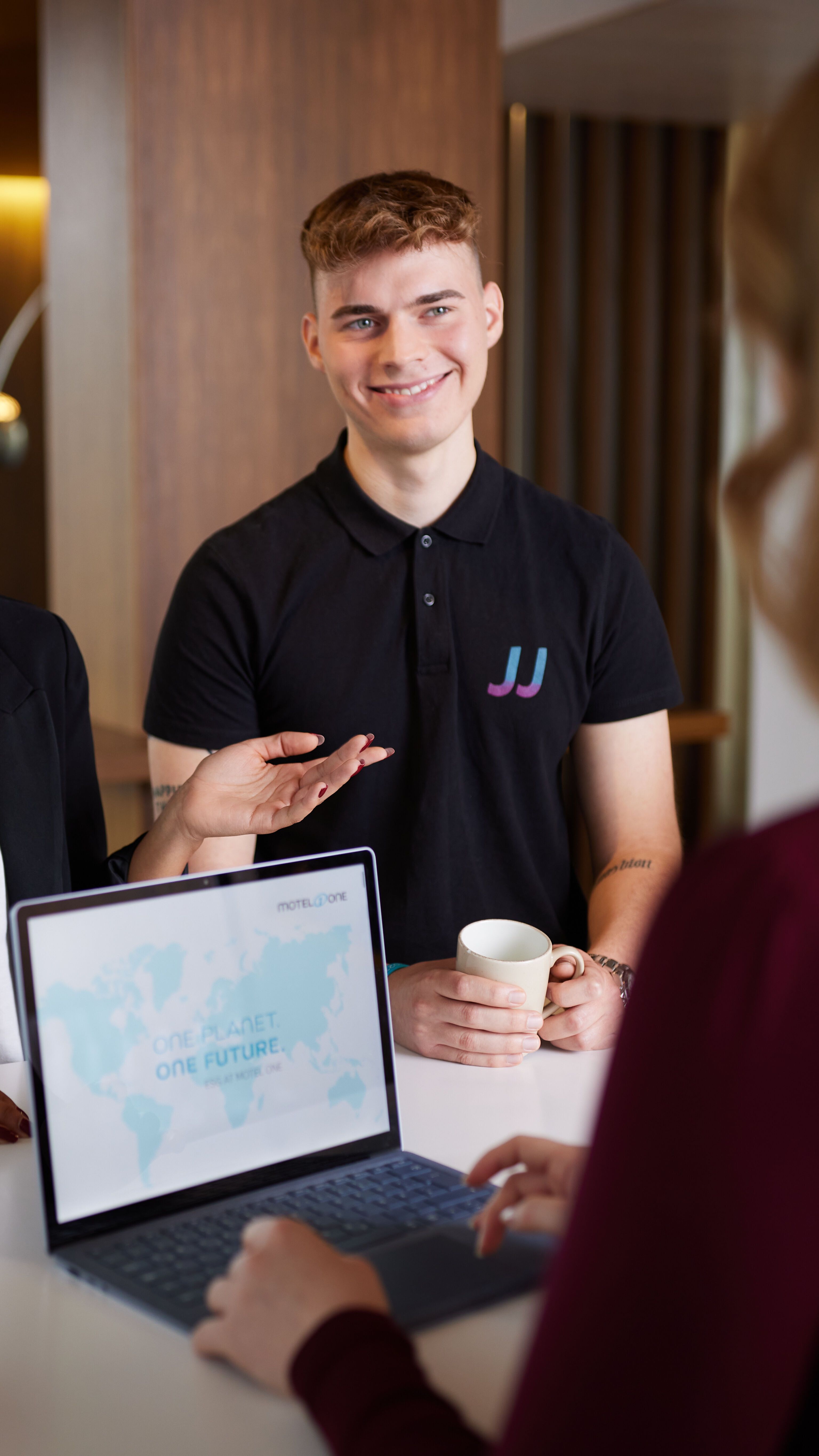 Motel One employees group talking to each other