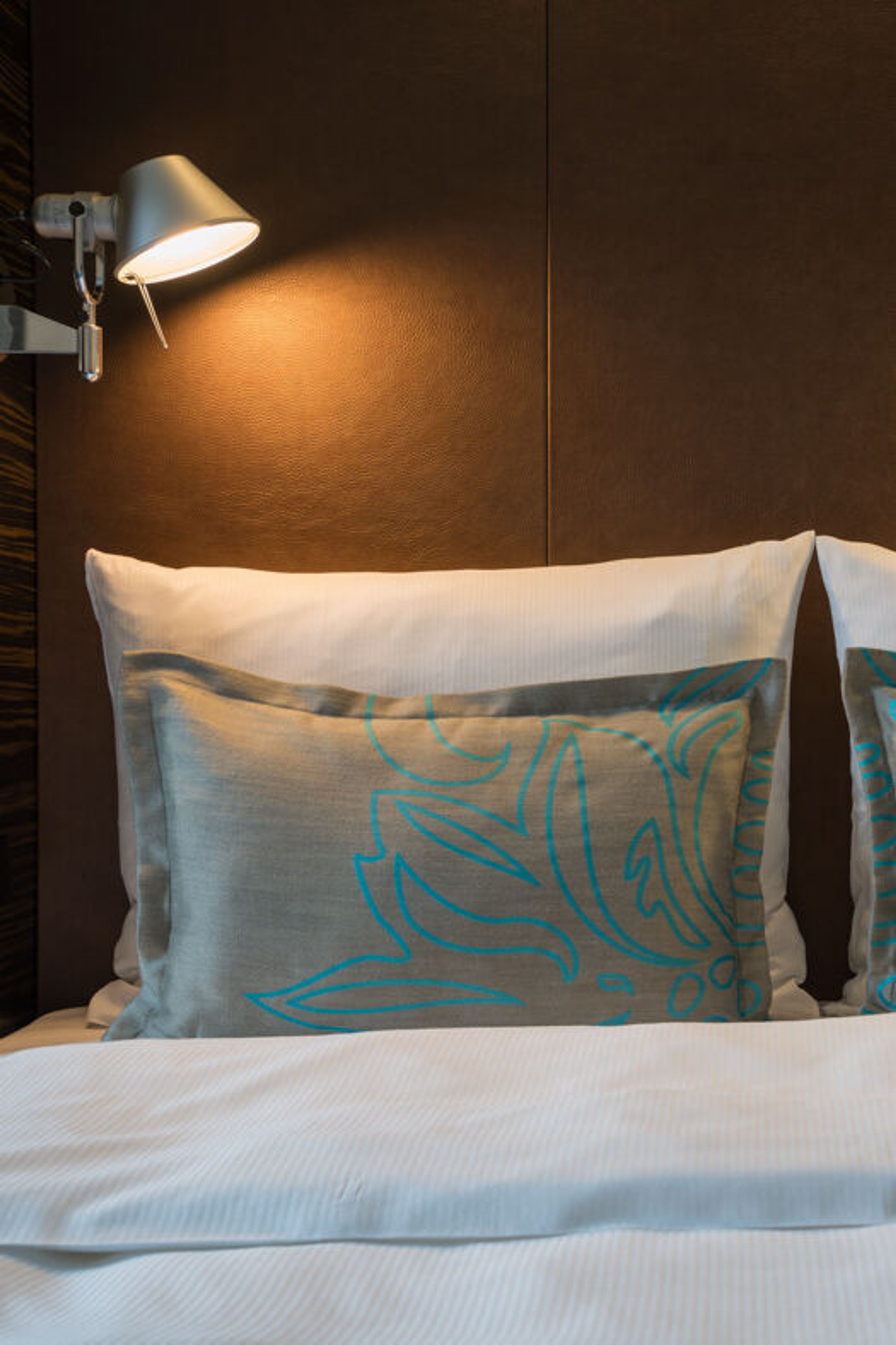 Designhotel Leipzig Nikolaikirche Motel One Doppelbett mit zwei weißen Kissen sowie zwei gemusterten Zierkissen Designhotel Leipzig Nikolaikirche Motel One Doppelbett mit zwei weißen Kissen sowie zwei gemusterten Zierkissen
