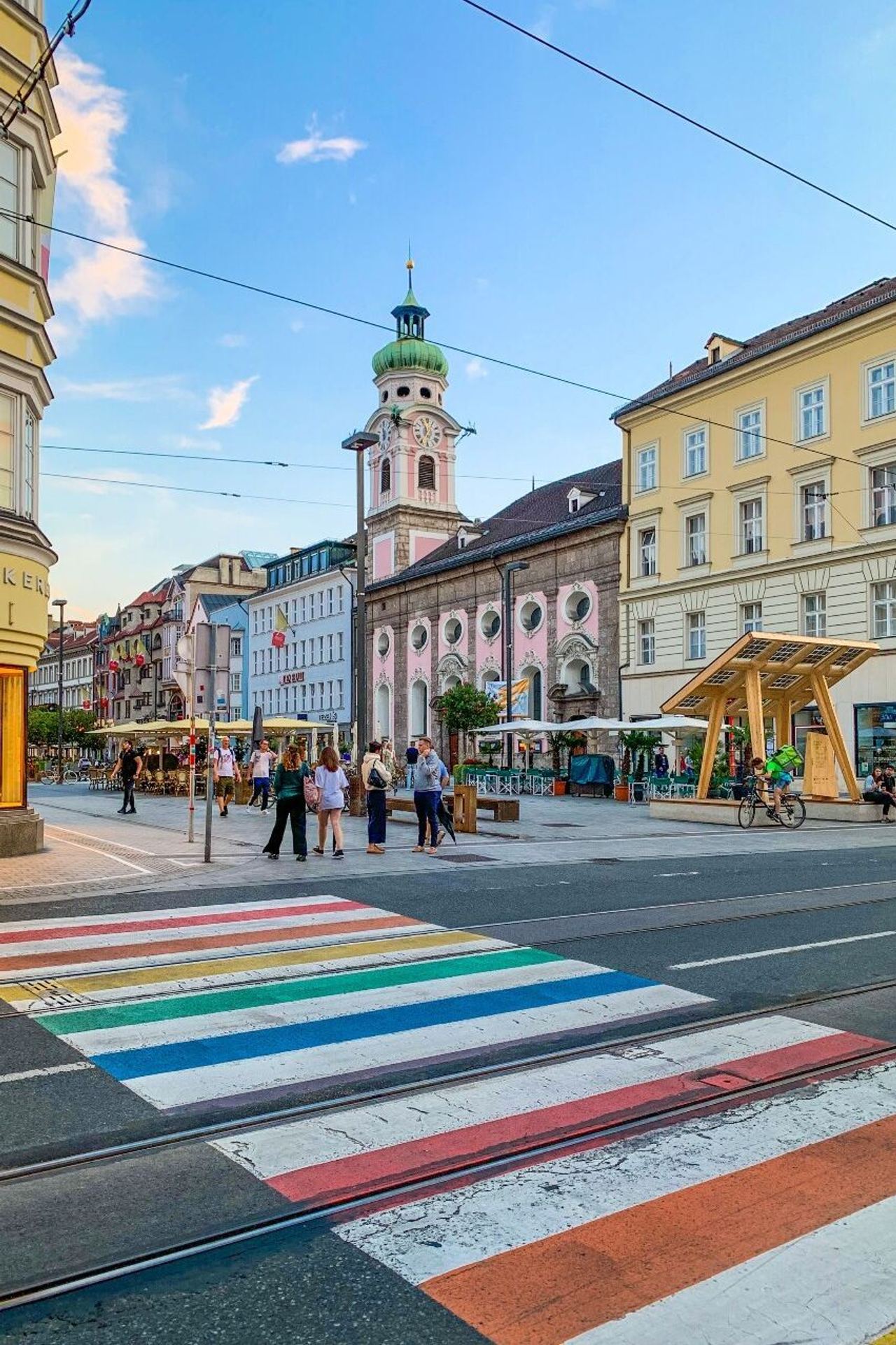 hotel Innsbruck city center with crosswalk in rainbow colors in the foreground