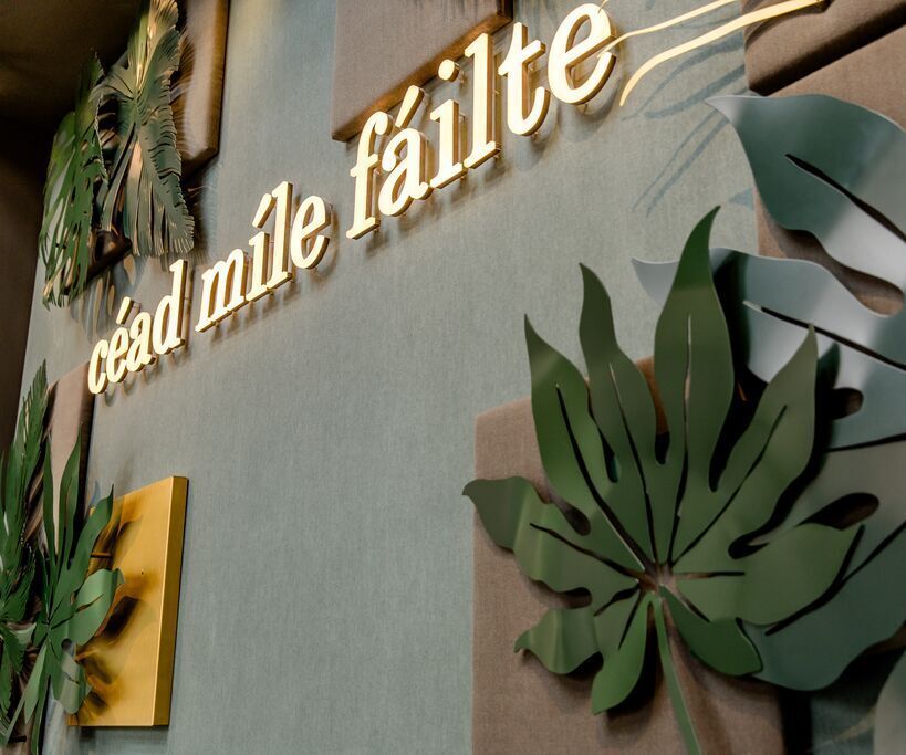 hotel Dublin Motel One wall decorated with leaves and the words “céad mile fáilte”